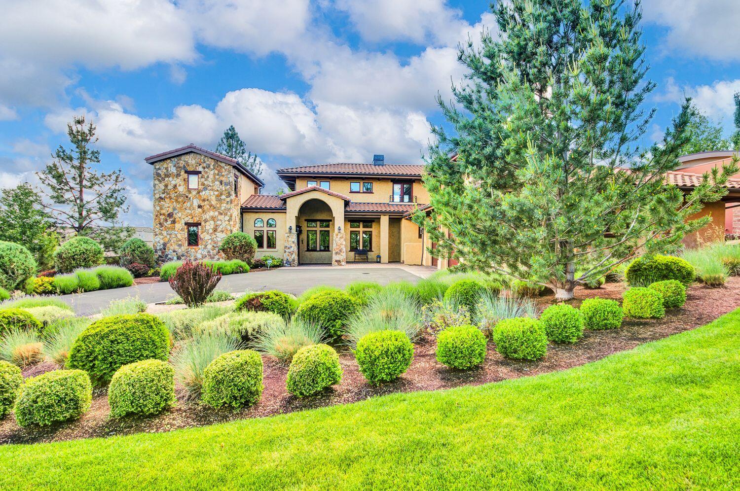 Beautifully maintained Tuscan Villa located in one of Bend's Premier Neighborhoods, Hillside Park. At 5,365 sq.ft, on a ½ acre lot, this home has plenty of room for friends and family to gather. 4 bedrooms, 3.5 bathrooms and 3 separate bonus rooms to enjoy. Stone patio with a wood burning fireplace, space to BBQ and a TV to let you enjoy summer evenings outdoors. A double sided gas fireplace sits between the living room  and dining area, opening up to a massive kitchen with 2 separate islands. One has a solid granite countertop with room to eat around, a built-in wine fridge and a second dishwasher. The second bar has a maple Butcher  Block countertop. Dacor Appliances, 2 dishwashers, a cabinet fronted refrigerator, and 6 burner stove top with 2 separate wall ovens will make this kitchen the center for gathering. With hardwood flooring, natural stone, carpeted bedrooms, 2 balconies, posey glass patio doors and windows, this home will meet the expectations of the discerning homeowner.