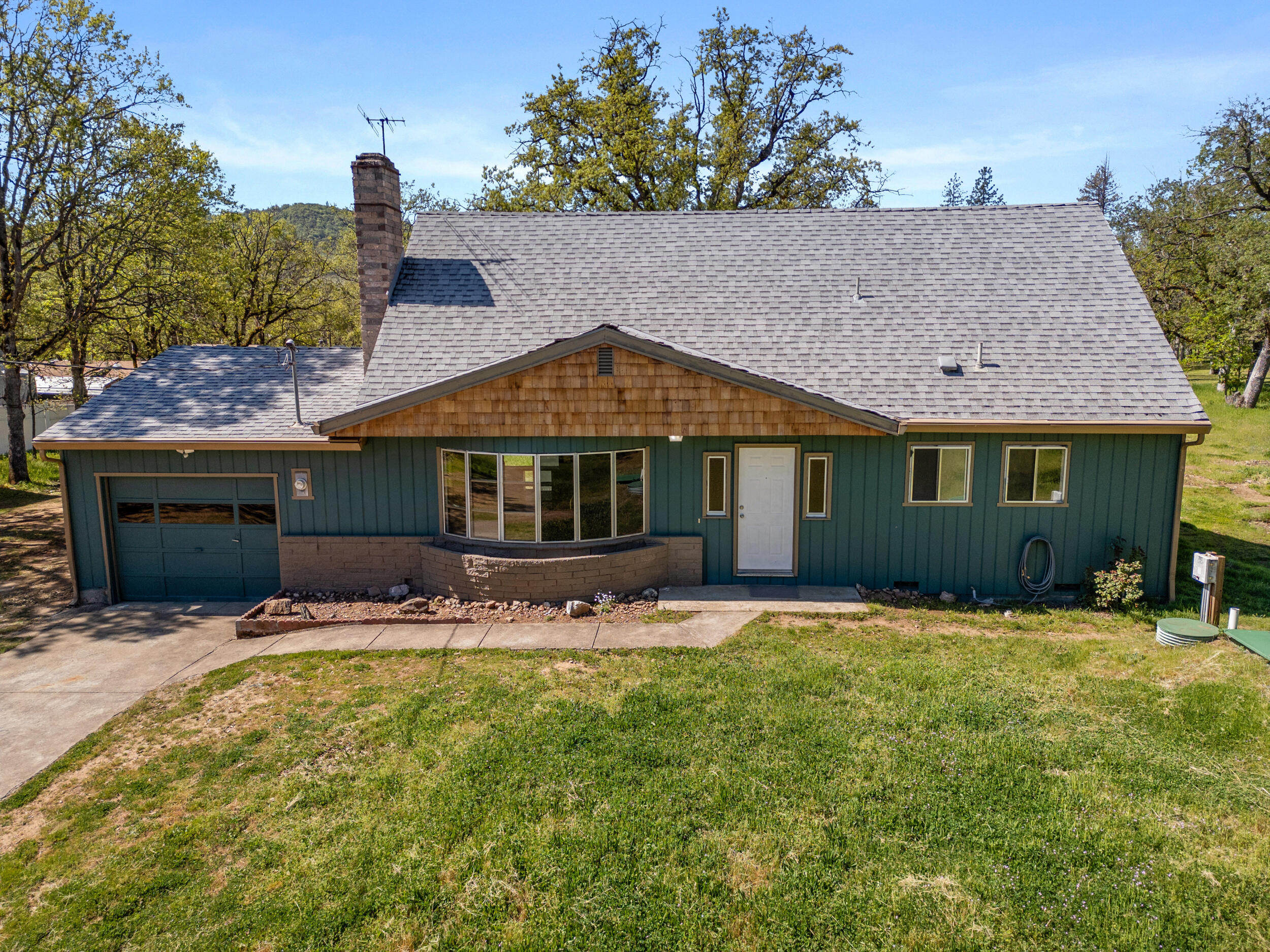 Unlock the potential of this contractor's special—a 1,664 sq ft two-story home on a fully fenced, level 2.07-acre lot ideal for animals, equipment, or future projects. This property offers strong bones and endless opportunity to customize, upgrade, or expand. Inside features a cozy living area with a wood-burning fireplace, ready for your vision and improvements. Outside includes a spacious shop, perfect for tools, storage, or workspace, along with ample room for gardening, parking, and outdoor activities. With flat usable land and plenty of space to create your ideal homestead, this property is a rare chance to build equity and design the rural retreat you've been imagining.