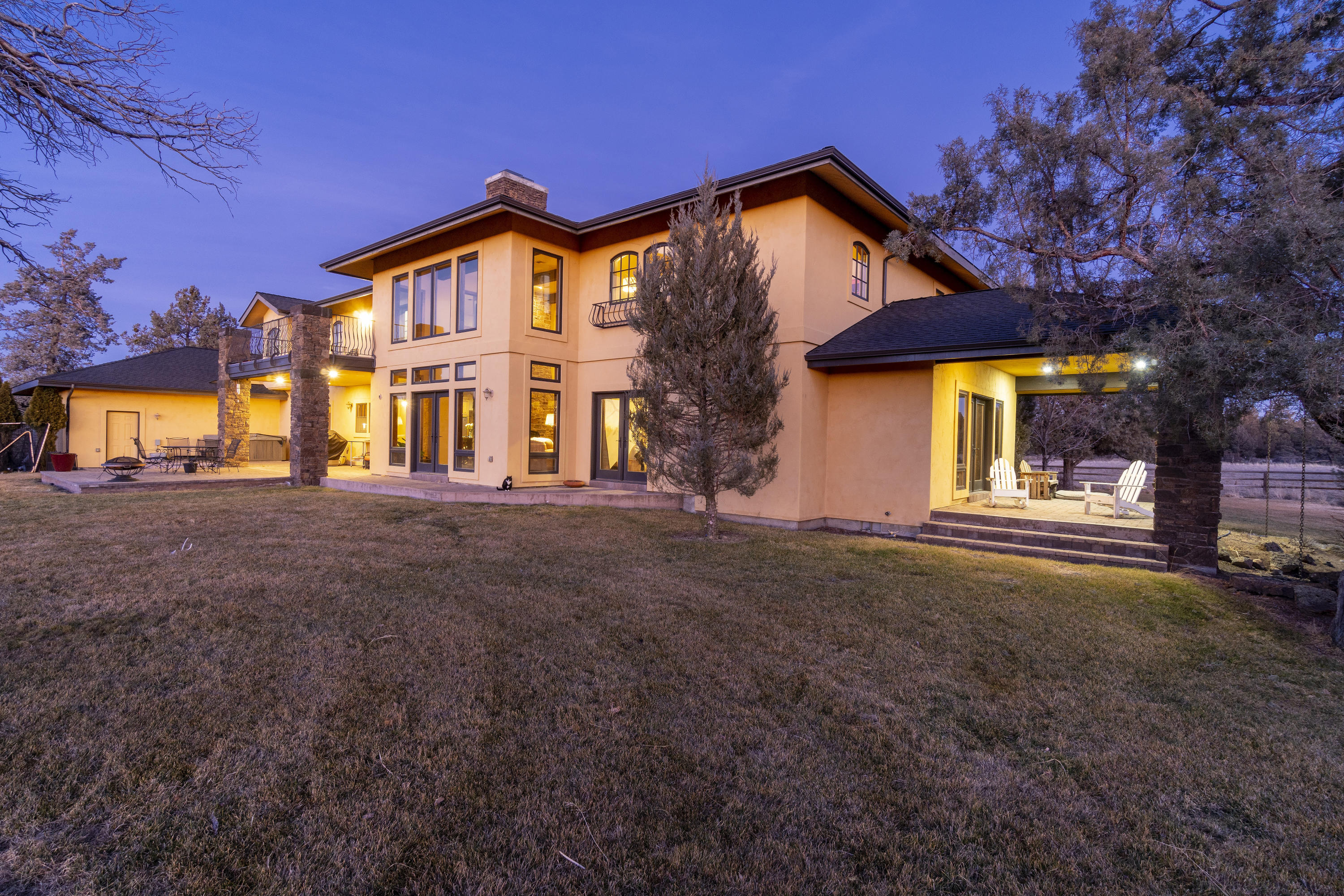 Presiding over 20+ acres in Bend Oregon this 6,705 sqft Mediterranean style villa exudes sophistication and clean elegance. The home spans 2 levels of
timeless contributions and the highest level of craftsmanship and quality. The many amenities include a stately entrance with a towering staircase and intricate
railings. Heated colored concrete floors and knotty alder accents span the main floor with Hickory wood floors and tile upstairs. A commanding stone fire place
in the great room with see through fireplace into the chefs kitchen. Primary bedroom suite offers sitting room with fireplace and deck with views expanding to the Cascade Mountains. 4 additional bedrooms, 2 office spaces, game room and large laundry room and mud room with full bath. Additional accessory building that would be a great studio or separate office, barn and storage building. 8 acres of irrigation.
