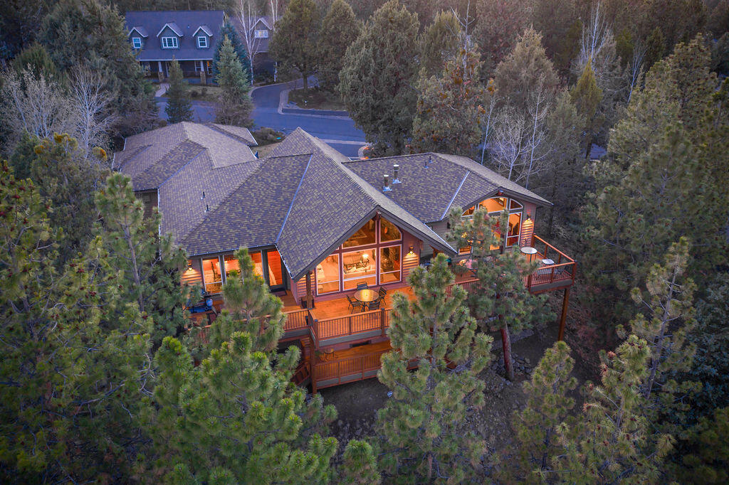 Extraordinary Custom home by DeMarco Design located in the private & gated community of Awbrey Glen on Bend's Westside. Nestled among the pines above the 12th Fairway, the private, contemporary/NW style home sits on .99 of an acre w' Tree Top Views. With 4041 Sq Ft the home has been thoughtfully constructed, w' soaring exposed timbers in the GR & walls of glass for natural light. 3 spacious ensuite bedrooms w' the primary on the main, 3 full baths w' stone flrs & counters, a powder room, 2 add'l bedrooms, office, media room w' wet bar & 1200 bottle temp controlled wine rm.  A chef's kitchen w' slab granite cnters & kitchen island w' bar seating, SS appliances & abundant storage. Cherry Brazilian HW floors, Vertical grain 8' Douglas Fir 3 Panel Interior Doors, Finish Casing & Trim.  Western Cherry HW cabinets throughout w' Patina Wrought Iron Handles. A 1600 sq ft deck serves for a perfect spot for entertaining. 3 car garage w' carriage doors. See Documents for specific details.