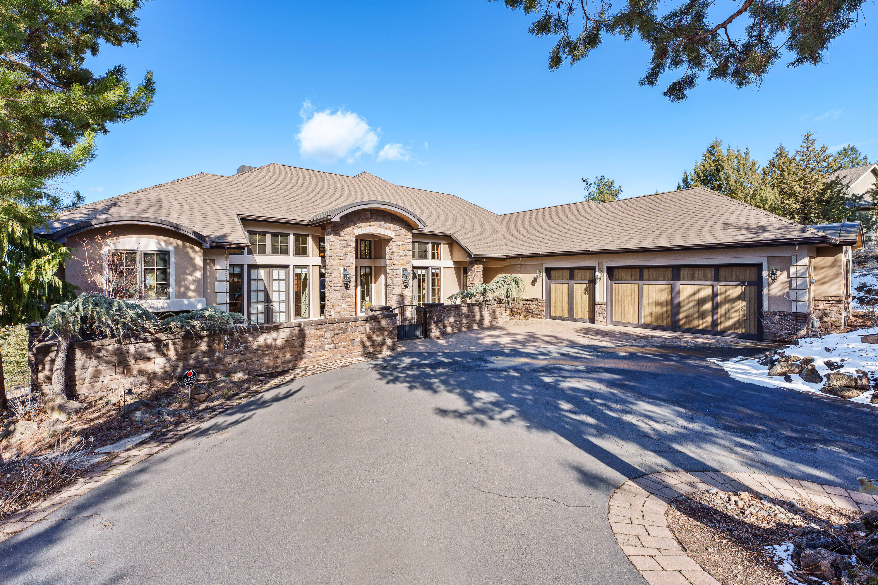 Experience the epitome of luxury in this custom-built single-level home. Be welcomed by panoramic mountain views from nearly every room. The heated floors run throughout the house, making every step a warm indulgence on those cold, winter nights. The gourmet kitchen features an oversized island and is equipped with two ovens and dishwashers, perfect for both intimate dinners and grand parties. All bedrooms are ensuite with separation from the primary and guest rooms. The large Primary suite boasts a huge custom closet - a steam shower and spa tub. Office with beautiful built -ins. The basement with separate entrance houses a wine room, plus a large area perfect for an art studio. A 3-car garage completes this home, offering ample space for your vehicles and storage. Refined living in this stunning home!