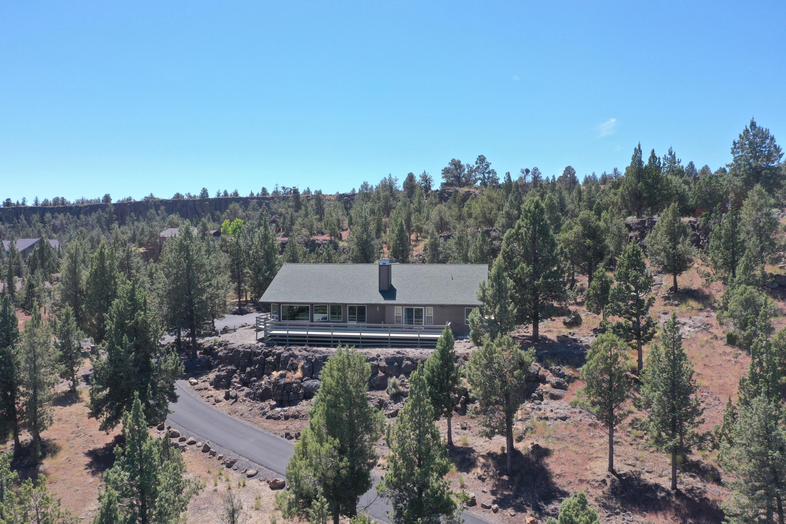 Discover a stunning custom-built home on 5 acres with breathtaking views of the O'niel Valley and Ochoco Mountains. This private 3-bedroom, 2.5-bath sanctuary features tongue and groove vaulted ceilings and expansive windows, allowing you to take in the views. The open floor plan and large kitchen make a great place to gather and beautifully updated bathrooms include a soaking tub with a view and large walk-in tile shower. Enjoy seamless indoor-outdoor living with a deck that spans the full length of the home, perfect for entertaining or relaxing. Additional amenities include a fully paved driveway, a heated garage complete with a dog wash station and a kennel. This home is a rare gem that combines luxury, privacy, and spectacular views.  Recent upgrades in the past 3 years include mostly new kitchen appliances, new roof, new heat pump & A/C, new floats in septic system and septic system was pumped and had a DEQ certified inspection 4/24.