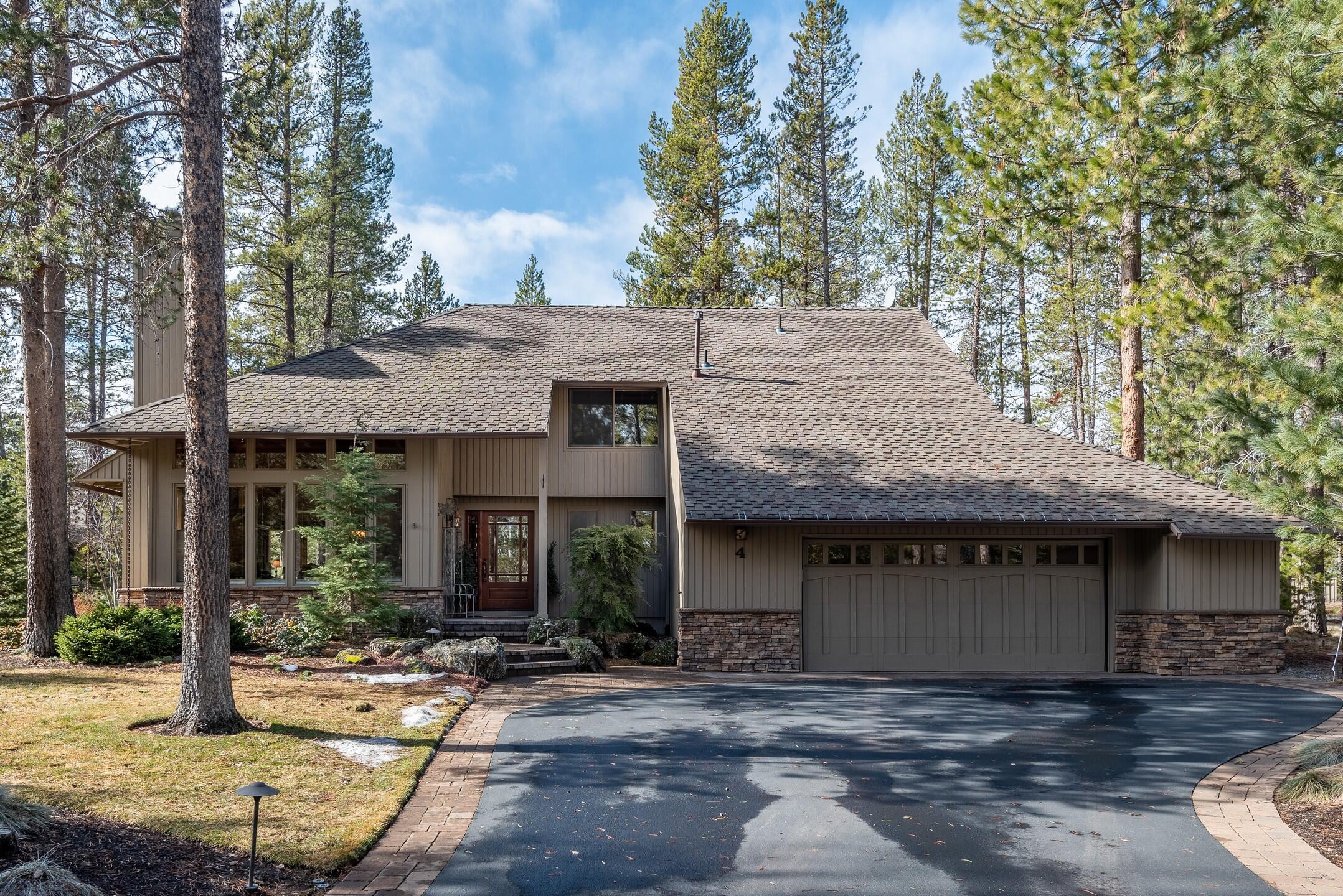 Nestled in the pines in a quiet cul-de-sac, this Sunriver home offers a cozy charm with custom natural finishes and upgrades throughout.  On the main level, enjoy an open great room with beautiful Brazilian cherry hardwood floors, travertine tile, cedar shed ceiling and a stone gas fireplace. Floor to ceiling windows bring a light and bright feel to the home. The kitchen includes granite countertops, skylight, double ovens, new dishwasher, custom cabinets and lots of light. One of the two master suites is on the main level along with a guest bedroom, powder room and laundry room.  Upstairs you will find a spacious 2nd master suite with vaulted ceilings, heated travertine stone floors, a large jetted soaking tub, large walk-in closet, storage and private balcony. Soak in the peaceful forest setting enjoying the serene water feature on your back custom paver patio. An oversized 2-car garage provides plenty of storage space. 16 miles south of Bend.