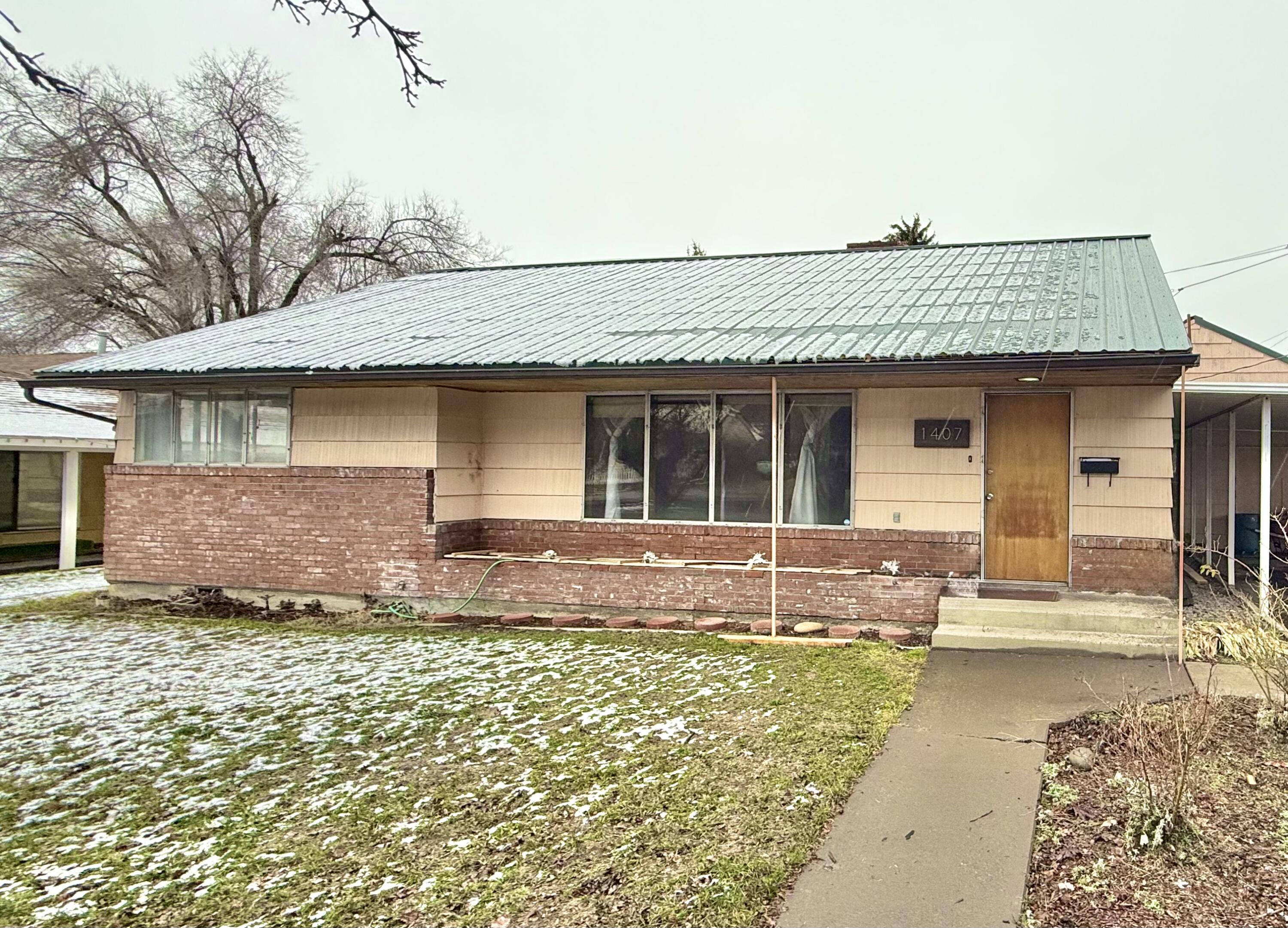 Single level 4 bedroom, 2 full bathroom home with brand new metal roof. This home offers a large living room with lots of natural light and a functional kitchen with extra storage. Newly remodeled bathroom and some flooring. Wood flooring through some of the house adds a charming touch! Garage is currently used as storage but could be converted back into a garage. Carport for covered parking. So much to love about this home, come see for yourself!