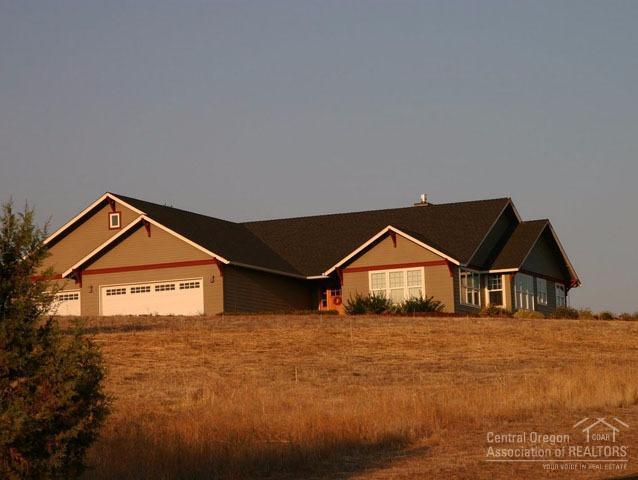 Great mountain views. Home sits on top of hill. Bonus room over garage (250 sq. ft. not included). Huge paved parking areas for all your toys. Gas fireplace, hardwood floors, high vaulted ceilings, near mint condition & move-in ready! Underground sprinkler system and two fences. This is a must see!