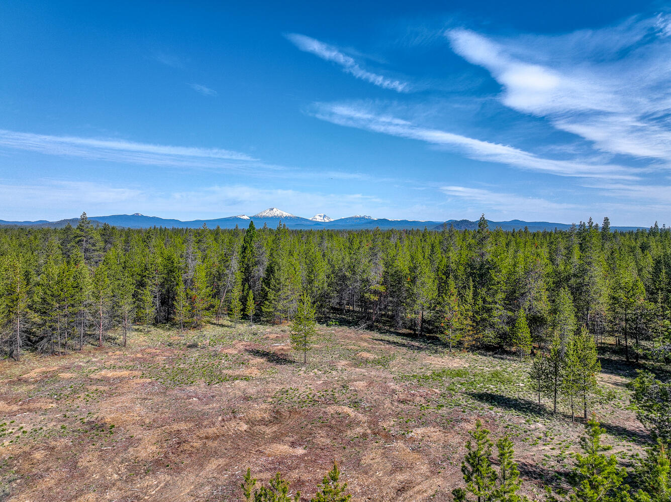 Exceptional 13.26 Acre Home Site in the Greater Sunriver Area! This peaceful property is in Pinewood Country Estates a neighborhood w/all newer custom homes, just minutes from Sunriver Resort & Caldera Springs. Enjoy paved biking/walking trails, Cascade Lakes, fishing the Deschutes & Fall Rivers, & Bachelor Ski Resort.  Property features & New Improvements: +/- 1.25 acres cleared ready to build, transformer w/capacity for a 400AMP power service, well w/18 GPM. Cascade Mtn views possible w/single level home! Parcel approved driveway permit, ATT Septic System & Sand Filter approved by DEQ. County maintained paved roads & snow removal. Watch the resident deer & elk roam from your back porch. CC&R's allow horses, llamas, chickens, multiple accessories & outbuildings. This is one of the only remaining lots available in Pinewood Country Estates. The privacy, proximity to recreation, and a neighborhood of 10+ acre parcels is what makes this property perfect to building your dream home.