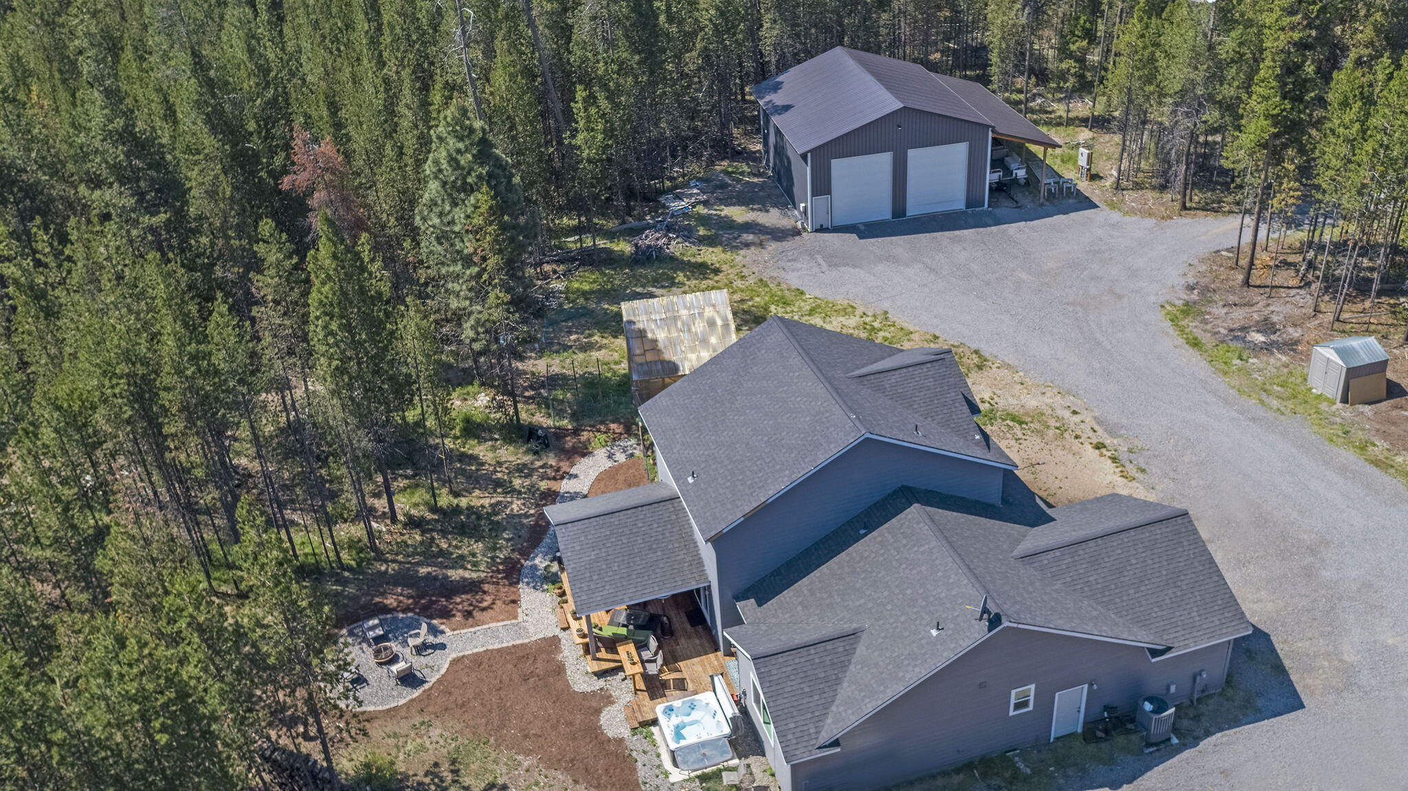 Rare opportunity to find a home in Three Rivers South on 2 acres with a 48' x 40' RV shop with lean-to, a full bathroom, loft and full RV hook ups. Enjoy growing your own vegetables in the green house that has water and power. The home was built in 2018. Incredible functional floor plan features a gas fireplace in the living room. Laminate flooring throughout the main level. Nice kitchen with a pantry, stainless steel appliances, breakfast bar with granite counter tops. Dining area with access to a large, covered deck with surround sound, ceiling fan and custom built in tables. The primary is on the main floor with a large bathroom with dual sinks, soaking tub and walk in shower. 2 additional bedrooms upstairs and a bonus room. Enjoy the outdoor living space where you can relax in the hot tub and take in the stars or cozy up around the firepit. Home Appraised for $859,000 this summer!