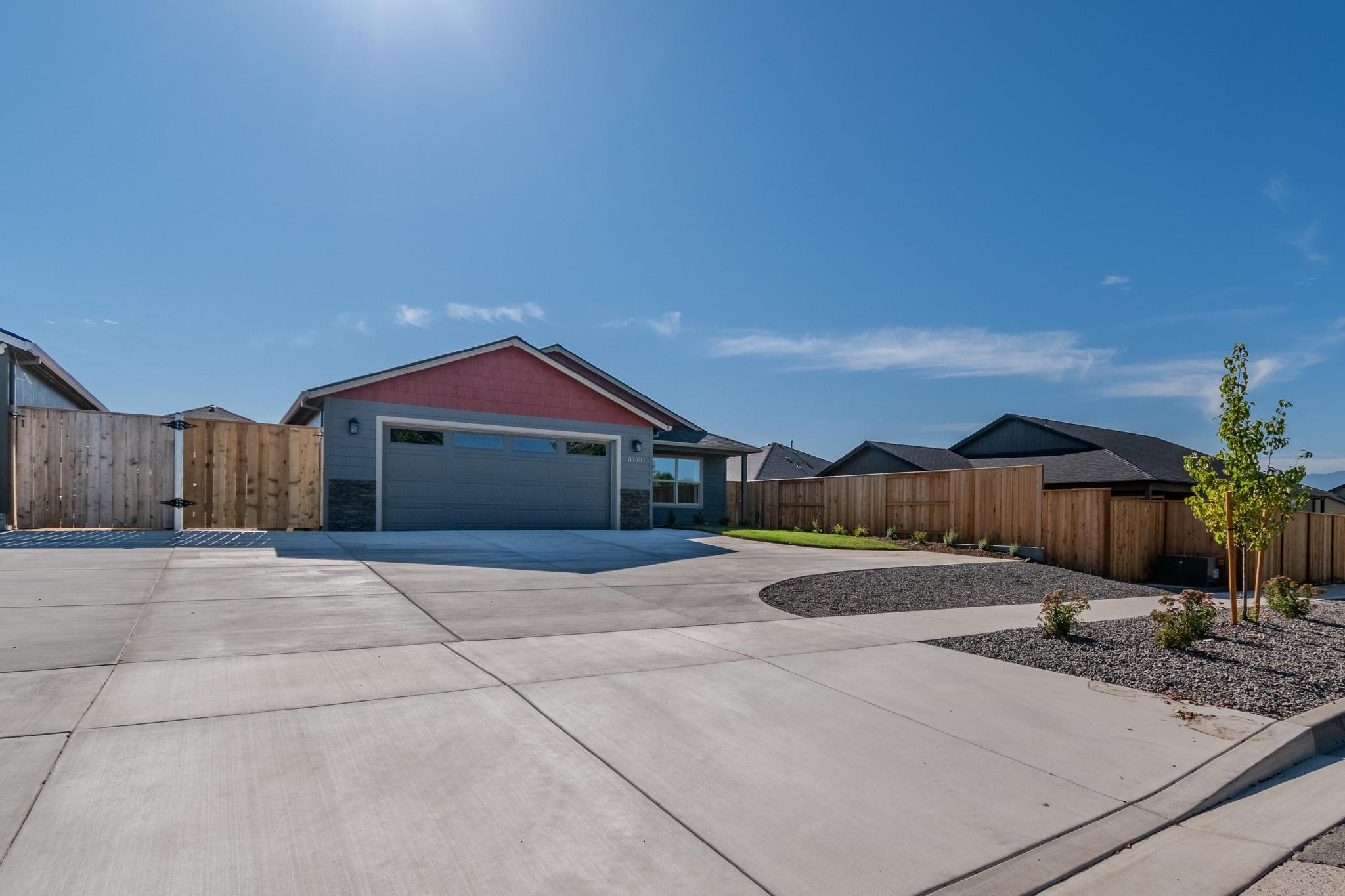 Discover this awesome new construction 3-bedroom, 2-bath home featuring a large vaulted family room perfect for entertaining. The completely landscaped lot offers extra parking and is fully fenced with sprinkler and drip line systems for effortless maintenance. Inside, you'll find modern stainless steel appliances and thoughtful design throughout. Relax on the covered back patio while enjoying the tranquil setting in a quiet part of town. Located in the desirable North Medford School District, this move-in ready home combines comfort, convenience, and quality construction in an ideal location.