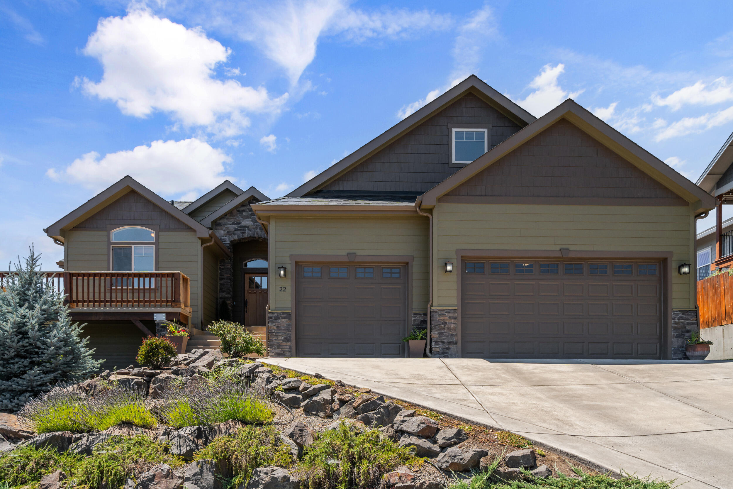 Craftsman-style home with expansive mountain views! Great room with vaulted & 9-ft ceilings, wood laminate flooring, and Alder interior doors. The island kitchen includes granite counters, stainless appliances, Knotty Alder cabinets, a walk-in pantry, and a large island with seating. Formal living and dining areas open to a wraparound covered deck, ideal for entertaining. The main level includes the primary suite with dual closets, double vanity, water closet, and tiled walk-in shower with duel heads, plus a second bedroom and full bath. The third bedroom is upstairs with a full bath, and walk-in closet, great for guests or office use. Oversized finished 3-car garage on the main level. Downstairs includes 1,000 sq ft of framed and plumbed space with separate entrance, ideal for rec room, additional suite, or storage. Recent exterior paint, refinished wood accents, tiered irrigated landscaping, RV parking with gravel pad and gate, and covered patio off the walkout basement.