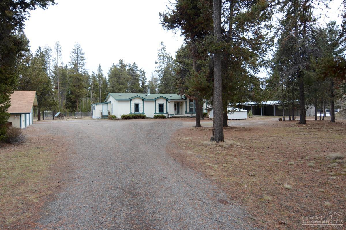 Equine estate nestled on a dead-end paved road. 2.19-acre corner lot is just minutes to Sunriver, Mt. Bachelor and the High Lakes. Borders 8 acres of common area w/direct access to the Deschutes National Forest. You will love the tranquility this property offers. Room to park your RV w/electric hookup. Detached double car garage w/separate storage attached. Barn wih 3-12X12, 1-12X16, hay storage or foaling stall, locking cedar lined tack room + 2 other outbuildings & outdoor arena. Inside the home features an open living area 4 bedrooms + office w/ built-ins. Large open kitchen, stainless appliances, mud room and so much more...