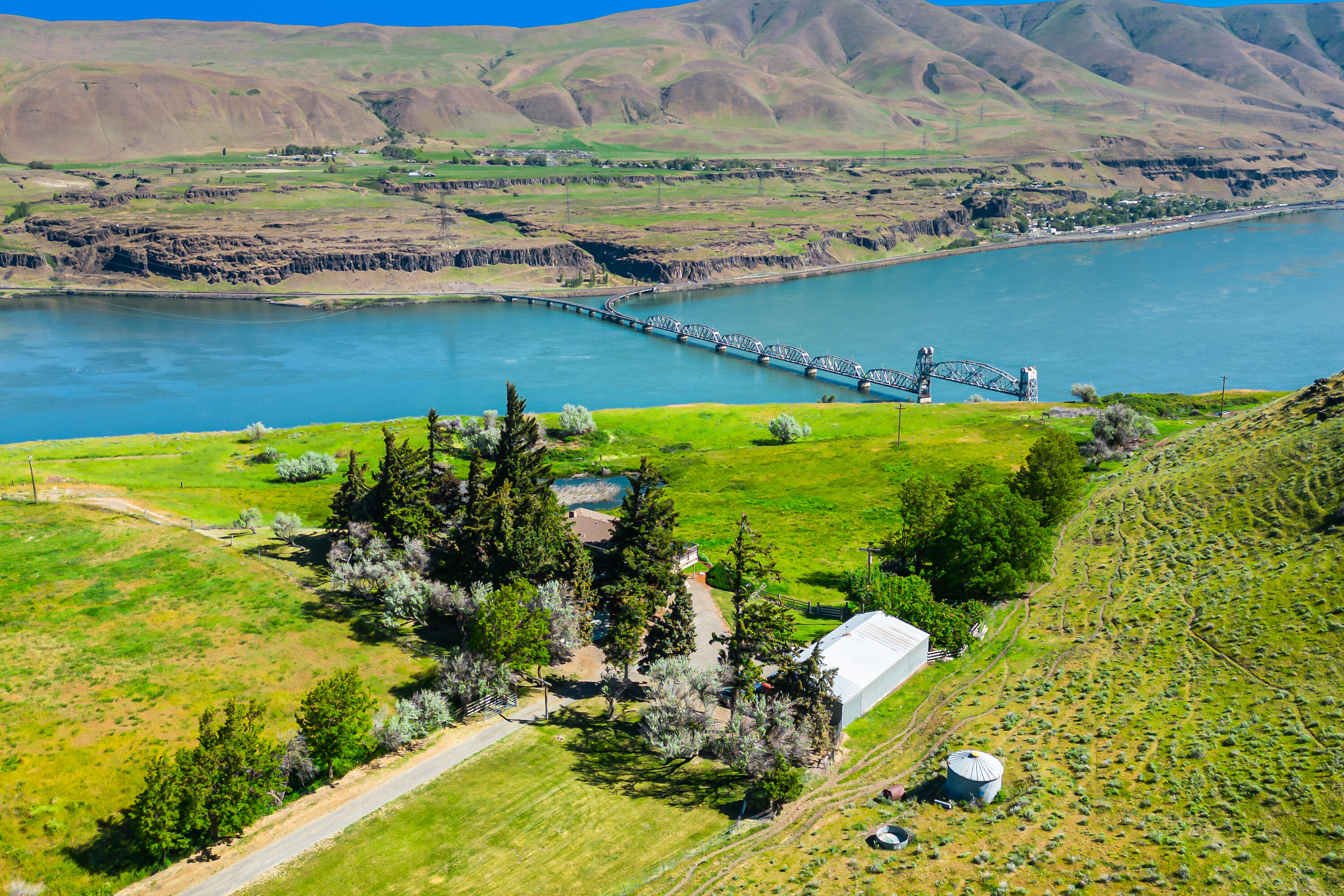 Escape to this 360-acre ranch overlooking the majestic Columbia River. This charming 3-bed, 3-bath home offers the perfect combination of modern comforts and natural beauty. Wake up to breathtaking views of the Columbia River from every room. With fishing opportunities just 4 miles away at the mouth of the Deschutes River, outdoor enthusiasts will find endless adventures at their fingertips. Surrounded by range land, this property is a haven for wildlife, including deer and various bird species. Additionally, outdoor enthusiasts will appreciate the dedicated rifle range, offering a space for target practice and outdoor recreation. A year-round pond adds to the allure, providing a peaceful retreat for relaxation and reflection. Equipped to accommodate equestrian pursuits, the property features a horse barn and cattle feed barn with steel corrals. Don't miss the opportunity to experience the ultimate blend of comfort and natural beauty at this remarkable property.