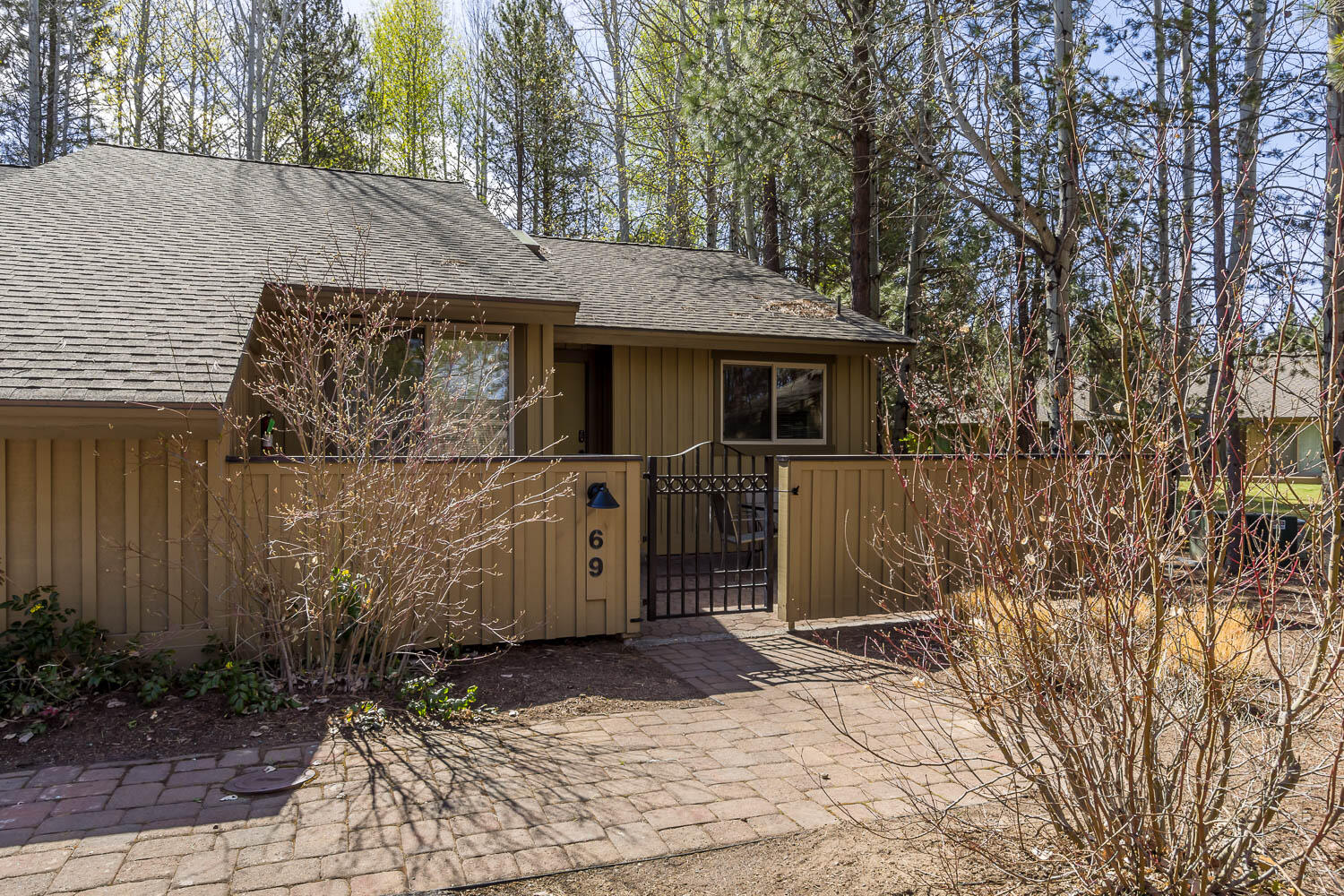 Make your way to 69 Quelah Condo. Single level, end unit that has had updated surfaces in the kitchen and in the two master suite bathrooms & showers. Classic Sunriver vibe with wood planked walls and vaulted ceiling in the greatroom. Wood burning fireplace. Two spacious master suites, one with a slider door to the back deck.  There is also an enclosed paver patio in the front.  Find the sun or enjoy the shade! Back overlooks a landscaped burm tastefully planted for privacy between neighbors. Located aprozimately 100 yards from Lake Aspen overlooking the Sunriver Nature Center. Great location near to the observatory, marina and stables. Quelah condo owners enjoy the use of their own pool, spa, tennis & pickleball courts. Located just west of Circle 3 close to the Sunriver Village and the Surniver Lodge! Come enjoy all that this turnkey unit has to offer!