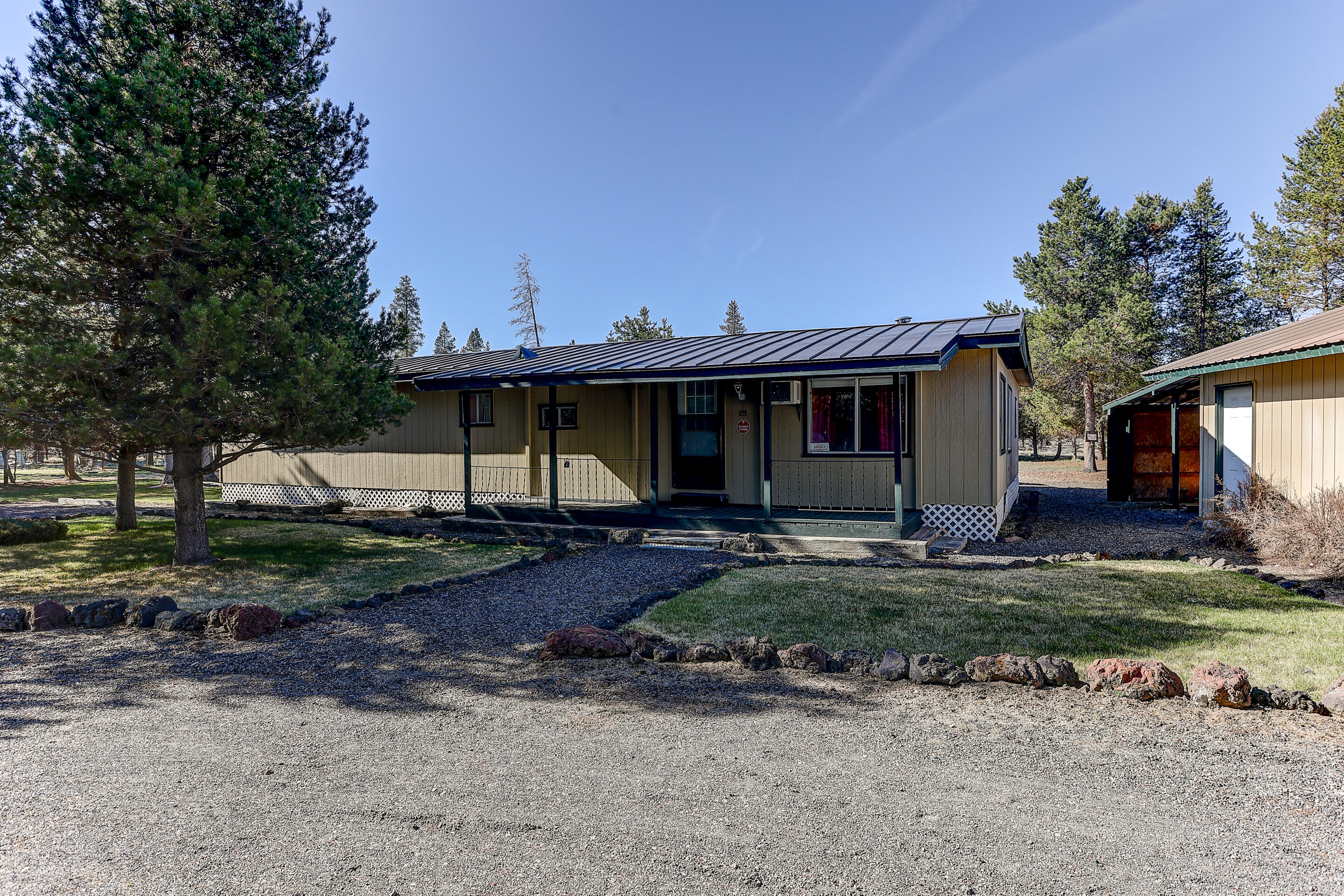 AS- IS Only! The MH needs some work but is livable- Almost an acres of property in Sun Forrest Estate boarding BML land! The property includes a detached garage, tack room and huge shop/RV or boat storage built in 2019. This 1970 MH home is Hwy 31 in Sun Forrest.   The property is zone R2 in Klamath County.  The circular drive and manicured lawn invites you in to the property.