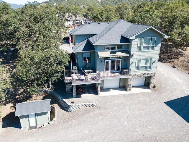 Incredible Custom Built One Owner Home in Beautiful Gold Rey Estates. Absolutely gorgeous views of Rogue River from nearly every picture window on the river side of the home. Excellent floor plan 2-story home w/modern design. PLUS huge heated 864 Sq Ft shop w/roll-up doors, finished upstairs perfect for extra hobby room, remote hoist, custom carport, & covered RV parking w/hook-ups. This home offers too many upgrades to list & situated on 2.26 acres. Custom wood details throughout. Real Hickory flooring, vaulted ceilings, custom gourmet kitchen w/walk-in pantry, ss double oven, counter-depth fridge, custom cabinets, granite countertops, more. Movie theater & oversized 2 car garage. Large master suite w/walk-in closet, jetted tub, walk-in shower & dual sinks. This house is in perfect condition. Custom landscaping w/fire pit & outside space is exceptional. Take in the views from the Appx 800 sqft Trex deck & electric awning providing shade. River access only 200 yards away. Must tour.