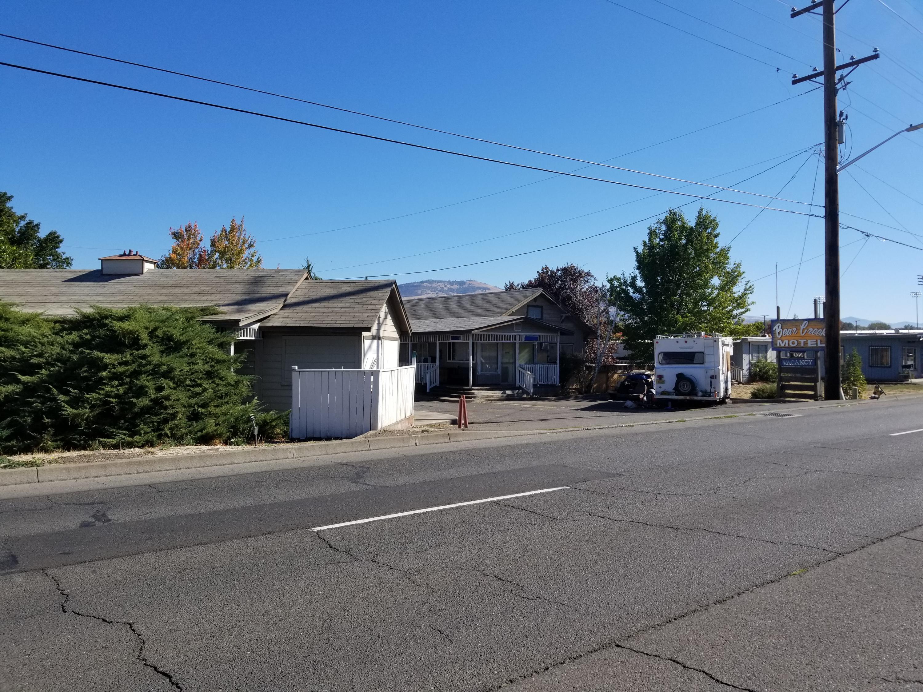 Fantastic opportunity for the right investor! The historic Bear Creek
Motel is located on S. Pacific Hwy offering approximately 400 ft of road frontage and prime exposure with a high traffic count. Close to the Bear Creek Corporation, the 1.4 level acres is centrally located with easy access to both the Medford and Ashland areas, and those in between. Although the
property is being primarily marketed as land, the improvements include 16 units which are in disrepair, that may have the
potential to be rehabilitated. Buyer would need to do due diligence to determine the feasibility of repairing the cabins. Could possibly be a great opportunity to provide short term housing. The location and versatility of this property offers many possibilities.