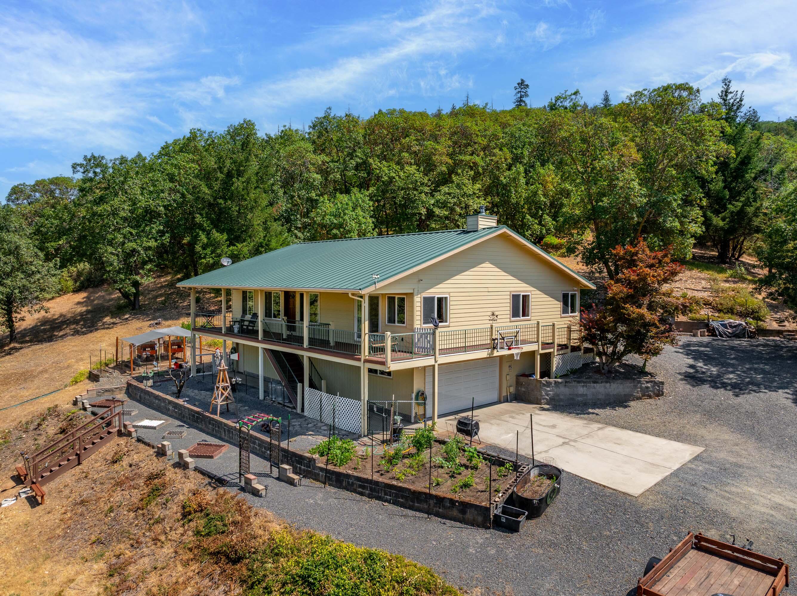 Welcome to your dream retreat in Southern Oregon! This spacious 3-bedroom, 3-bath home offers 2,080 square feet of well-designed living space, set on an expansive 13.72-acre parcel with breathtaking views in every direction. Built in 1993 and thoughtfully updated, this property combines privacy, comfort, and convenience just a short drive from town.

The home features a new HVAC system, enhanced fire protection, and extensive land improvement work already completed. The private suite includes a beautifully remodeled bathroom, offering a serene and stylish place to unwind.

Whether you're entertaining or simply relaxing, the gorgeous deck is the perfect place to take in the stunning Southern Oregon landscape.
Need space for vehicles, hobbies, or storage? You'll love the oversized 4-car garage. This is more than a home—it's a peaceful, private escape with all the modern comforts. The swim spa is included in the sale! Don't miss your chance to own a slice of paradise close to town.