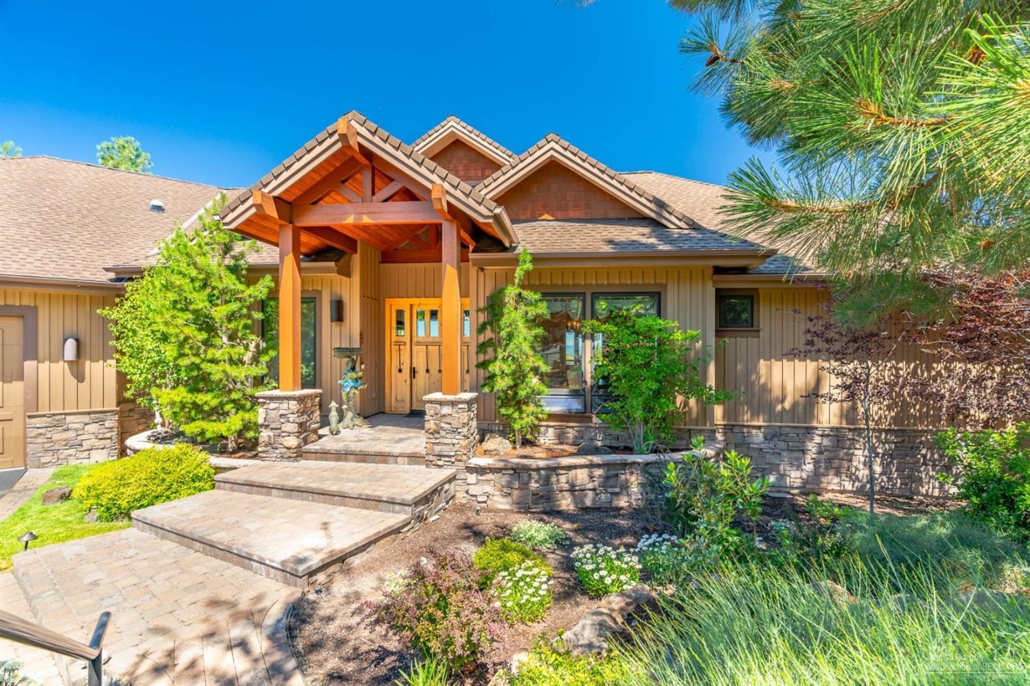 You'll stand in awe of the beautiful view of the Cascades from this stunning custom home on one of Awbrey Butte's most premier homesites. The home is beautifully appointed in all respects, from the fireplace, timbers & hardwood floors in the great room, to the design & quality of the kitchen & the tranquil water feature in the backyard. Main level master, office & deck, w/ cozy spaces for relaxation & entertaining. Downstairs bonus room, gym & 3 bedroom suites. Garage is over 1100 sf & driveway is heated.