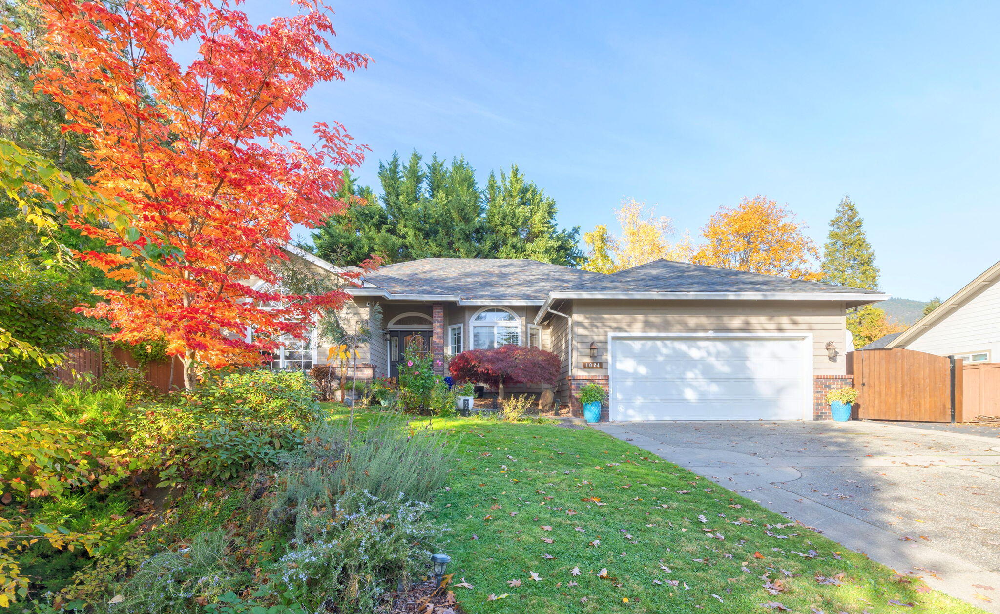 Tucked in one of Grants Pass's most desirable areas, this 3 bed, 2 bath, 2012 square foot home blends comfort, privacy, and thoughtful design. Featuring hardwood floors, vaulted ceilings, and large windows that bring the beautiful outdoors inside. The open layout connects the kitchen, dining, and living spaces, highlighted by a gas range, kitchen island, breakfast bar, skylights, and a fireplace. The primary suite includes a jetted tub, walk-in shower, dual vanity, and walk-in closet. Outside, enjoy a peaceful .41 acre lot with mature landscaping, fruit trees, garden boxes, and a flowing water feature leading to a space for a hot tub. Covered patio, finished craft room/workshop with mini-split, RV parking with full hookups, newer roof and HVAC, and a fully fenced yard with sprinklers and drip system. Creek borders the property for a private, park-like feel. Do not miss your chance to own this slice of paradise in town!