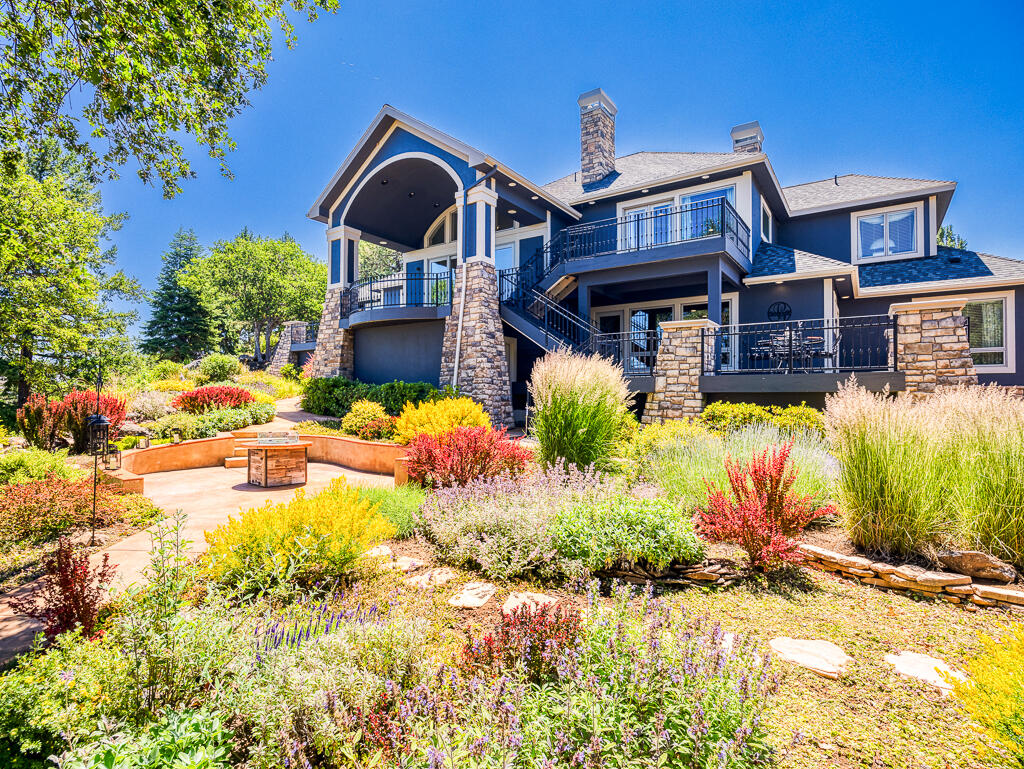 Rare 2.60 acre at Running Y Resort.  Lake view & unobstructed, outstanding vistas all the way to the Crater Lake mountain range. Perfectly landscaped with a bubbling creek water feature & cascading decks all surrounded by gated custom ironworks so dog or munchkins don't escape. Looking for that wow factor when you walk in the front door?  Vaulted and coffered ceilings, recessed lighting, hardwood floors, 3 suites, Living, dining & Media/entertaining areas, 2 guest baths, Wine cellar with temperature system. Office with built-ins.  Gorgeous kitchen has granite, island, desk area, pantry, wolf range, subzero fridge. Eating area & breakfast bar look out to lake & native rock garden. 3 tankless water heaters. Safe room. Wired for sound throughout. Parcel pantry off oversized 3 car garage. The master suite has double vanities, free standing soaking tub with views, tiled shower, fireplace & deck off bedroom for those quiet morning coffee thoughts. Privacy for yourself & your guests.