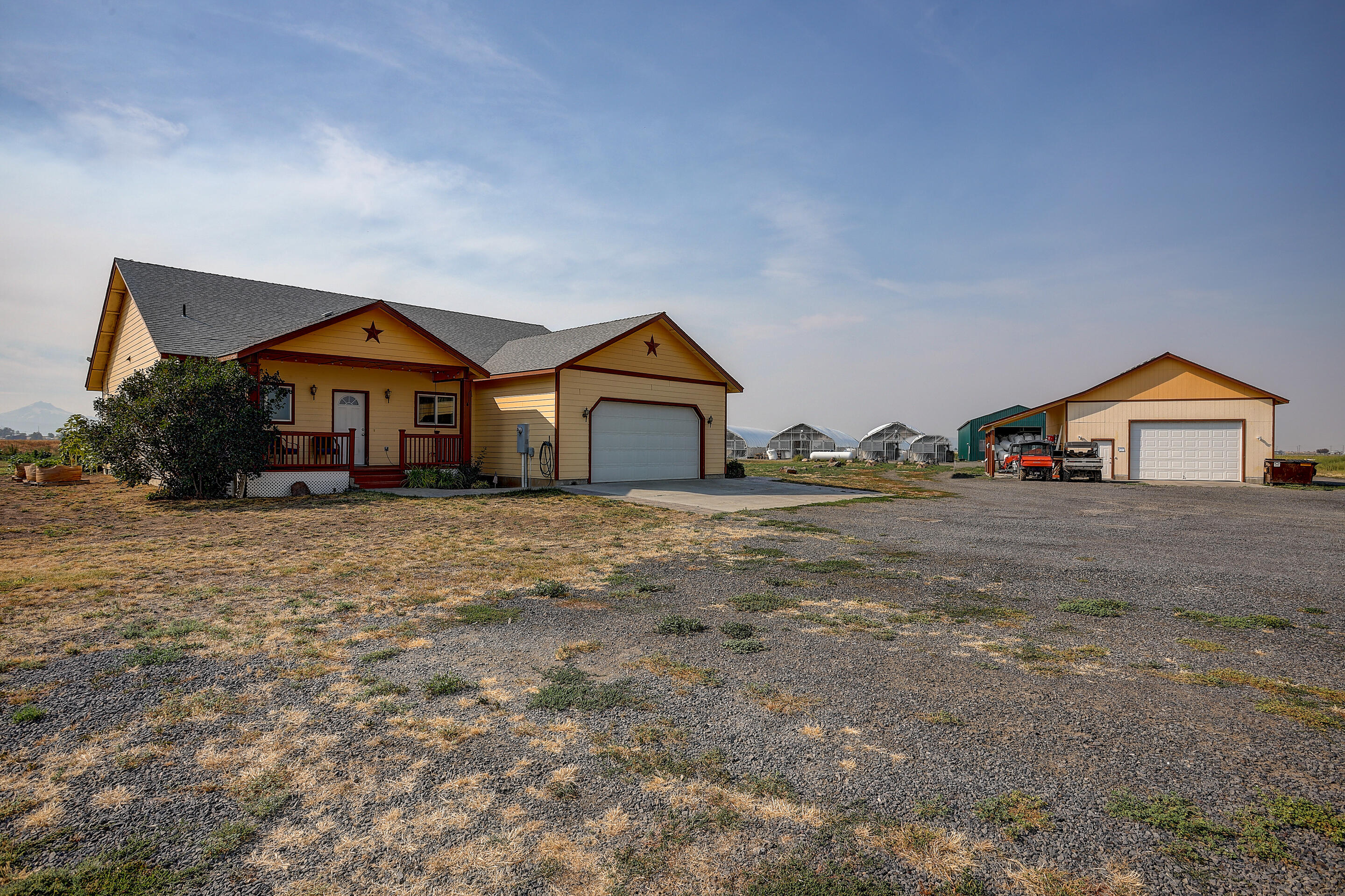This is a highly productive 150 acre farm with 147 acres of water rights.  Property comes with buried mainline, 6 wheel lines, and two 25hp pumps.  There are two homes.  One is custom built w/1800sq ft and 4 bedrooms, 2 ½ baths.  The second is a 2005 2674 sq ft triple wide manufactured home with 4 bedrooms, 3 baths.  Live in one and rent out the second for additional income.  Both homes support beautiful Cascade Mountain views.  A 4,000 sq ft multi use warehouse with a cement floor, power, and insulation is located on the property.  Also there are four large greenhouses.  Property is strategically located to take advantage of CO recreational amenities, including Lake Billy Chinook 10 min away, Smith Rock State Park 20 min, Mt Bachelor world class skiing, and many other reservoirs, High Lakes, all for fishing, water sports and camping.  Envision yourself on this beautiful property.  Call today for showing.