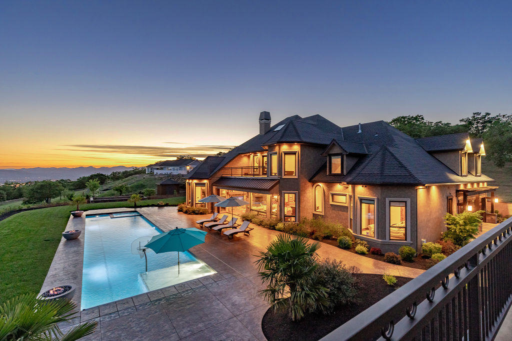 Experience the ultimate & gorgeous, custom Pagnini built home. Situated on 5.54 acres of Southern exposure & beautiful views. Nestled behind a private gated entry this estate includes a 6-car garage w/ 1604 sq ft guest quarters, in-ground pool/spa & basketball court. The exquisite home offers beautiful custom finishes w/ high beamed ceilings, unique wood finishes, lots of built-ins, grand windows, gorgeous flooring & a French country kitchen w/high-end appliances & custom finishes throughout. Escape to a grand main level Master Suite w/sitting room & spa features incl steam shower, dual heated floors, free standing tub, 2 closets, & gorgeous tiles. Additional bedrooms w/walk-in closets & full baths are located on the 2nd level. Work from a home office offering soaring grand ceilings & warm luxurious wood finished and cabinets. Entertain in the dining/family room w/ lg stone fireplace, or choose the formal dining rm, game room, or lg. bonus room. The setting is private & inclusive.
