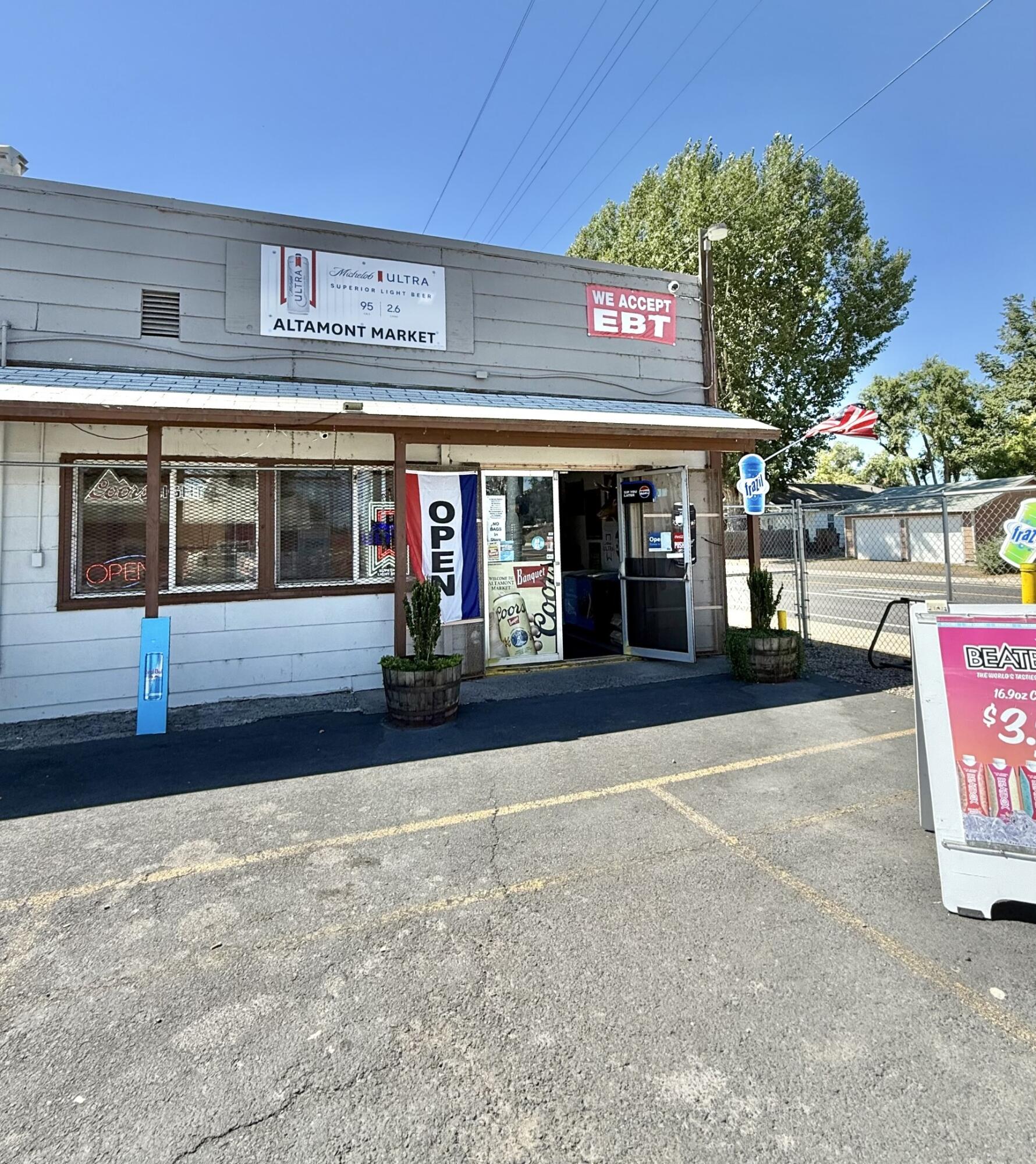 BUSINESS OPPORTUNITY! Altamont Market is a thriving business with 4.3% cap rate. Includes an attached 1 bedroom, 1 bathroom residential unit, great for either additional income to maximize your investment, or to be occupied by owner/manager. It is located on the corner of a high traffic intersection, and in a residential area for easy access. Close proximity to a school and other commercial properties. Deli area with 3 wash stainless steel sink, hand washing sink and prep area. There is parking area in the front and spacious yard off the residential side, including 4 locking sealed storage sheds. Additional gated/paved parking behind the store. Tons of updates and potential! Sale includes real estate property, business, and equipment. P&L and equipment list available. Call to book your viewing today!