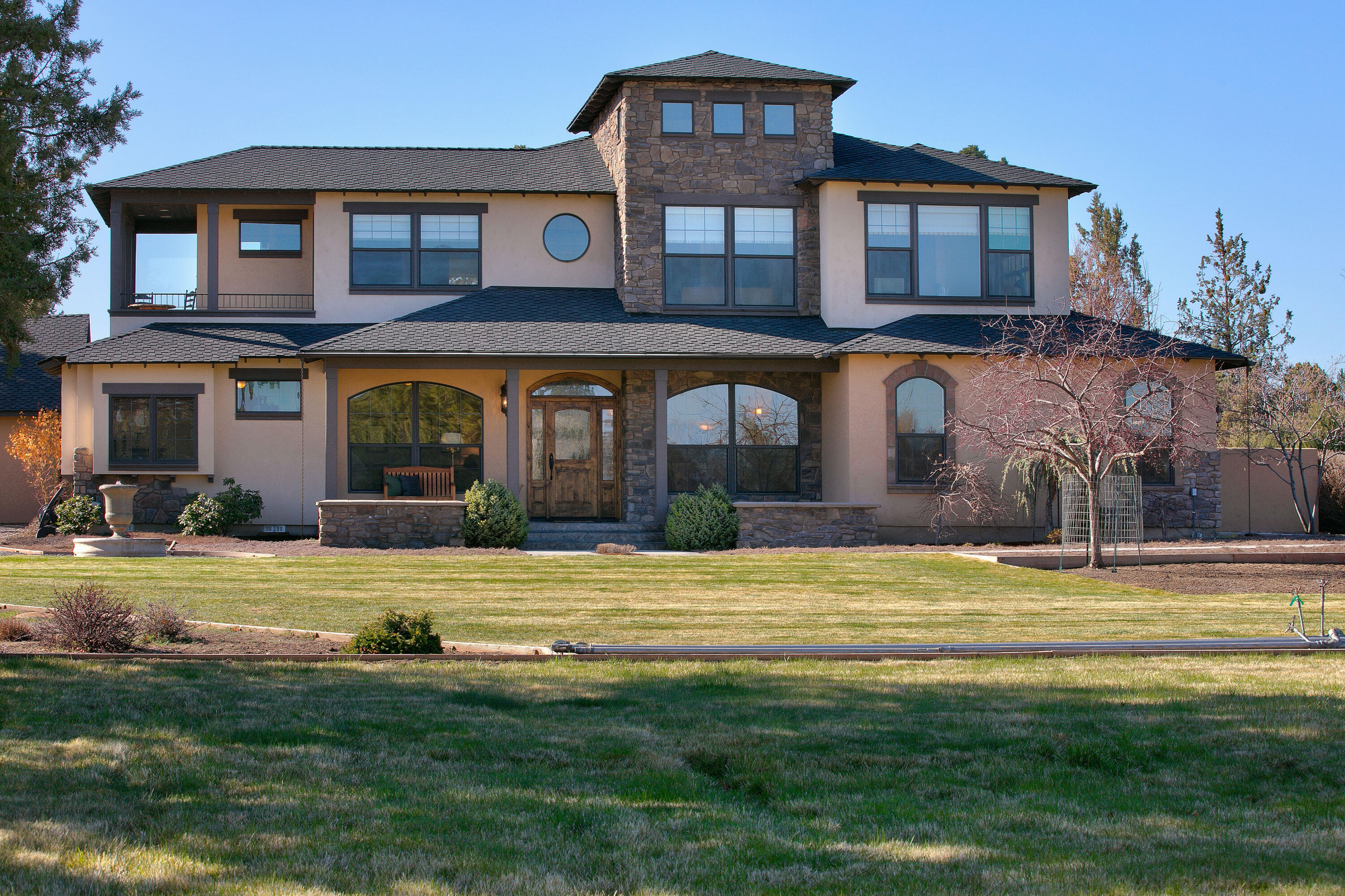 Exquisite Tumalo home sitting on 3.21 serene acres with stunning Cascade Mountain views! Pass the beautiful fountain out front into the entryway of the home where you'll find a sitting area/library and a formal dining room. Natural light pours into the Great Room with a statement-making rock fireplace surrounded by built in cabinetry. Eating area and Kitchen are off of the Great Room, featuring granite countertops, new Kitchen Aid fridge, wine fridge, dual oven, warming oven, and walk in pantry. Chefs dream! Primary Suite is on the main level with sitting area, spa like bathroom, his and hers closets. Upstairs is a second primary bedroom with balcony access, as well as 2 more bedrooms. Entertainers paradise out back with built in BBQ, sitting area and raised garden beds. Second detached garage/shop with electric car charger, ample attic space and workshop area. This home has everything and more, please see attached list of improvements!