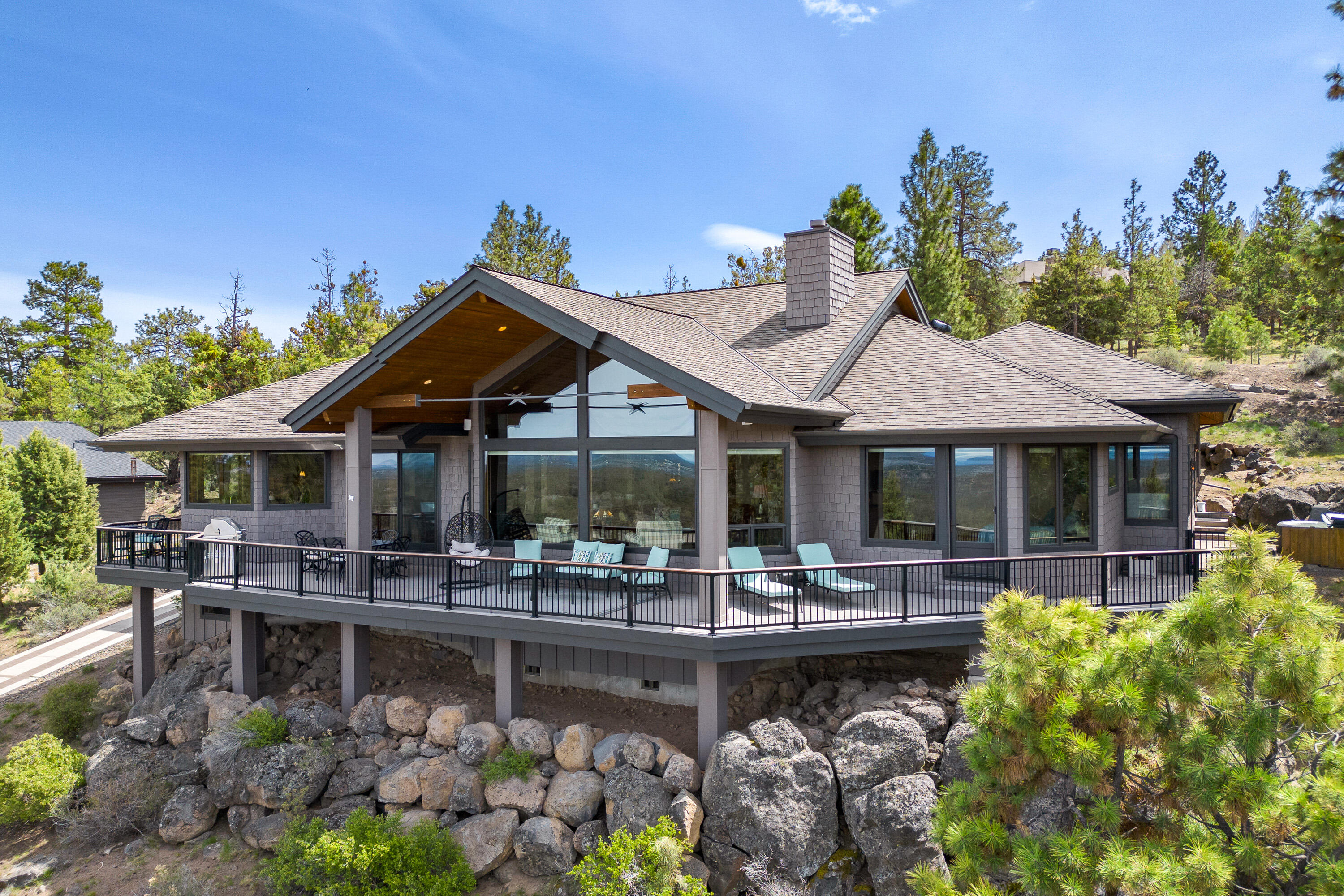 Stunning CASCADE VIEWS from this Awbrey Butte SINGLE LEVEL home with a 3-car garage! Custom features with an open floor plan, vaulted ceiling, stack stone gas fireplace w/built-ins, dining room, office w/ built-in desk & a bonus/media room. Kitchen w/Dacor stainless steel appliances, double ovens, 5 burner stove top, slab granite counters, farm sink, Medallion cabinets & pantry.  Primary suite has views, a gas fireplace & door to the deck.  Primary bath has dual sinks, tile counters, jetted tub, huge tile shower, & walk-in closet with built-ins.  Home features include Sierra Pacific windows, central vac, AC, solid fir doors, Hunter Douglas cell shades, radiant heat in primary bath/kitchen & surround sound. Garage has workbench, built-in storage cabinets & attic storage space. Waterfall feature, 800 SF of composite decking & a patio w/ a hot tub. HEATED DRIVEWAY (paved strips) with 2 parking spaces & a flat driveway at the garage entrance.  Plenty of storage under the house.