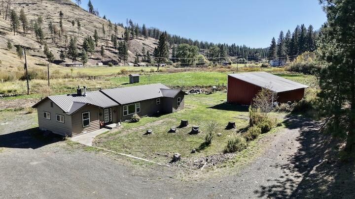 ATTENTION buyers! Seller is willing to give up to $4,000 seller credit for closing cost with the right offer.! Charming 5.39-Acre Hobby Farm with Creek, Pasture, and Forest Views Discover the perfect blend of natural beauty and modern comfort on this stunning 5.39-acre property. Set against a picturesque backdrop, the land features a fenced pasture and a serene canyon creek flowing through the back,p making it ideal for a hobby farm or horse property. Enjoy breathtaking views and endless recreational opportunities, as the property sits directly across from national forest land—home to abundant wildlife and outdoor adventure.Step inside to find a thoughtfully updated Ranch style home, boasting brand-new cabinets, stylish flooring throughout, and fresh paint inside and out. The spacious 1,602-square-foot home offers 3 bedrooms plus office/den, large laundry room and pantry and 1 bathroom. Outside, a large shop . Listing agent is related to the seller.