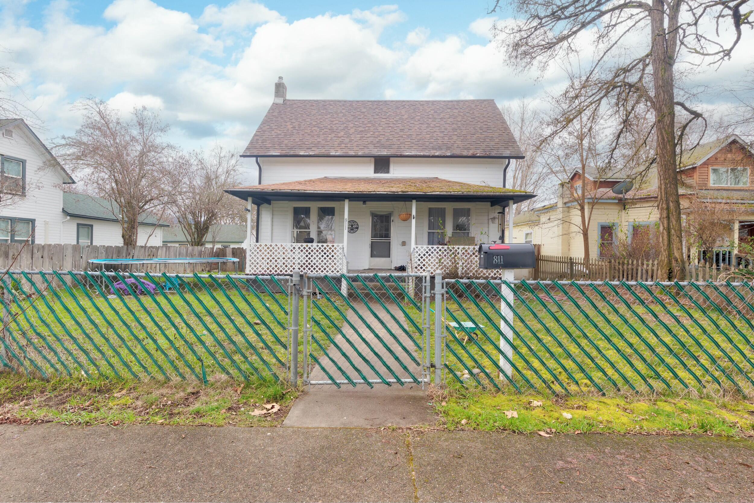 Welcome to 811 SW 4th St! This 1910 charming home features 4 bedrooms, 1.5 baths, with an office nook off of the living room, freshly remodeled bathroom with tile & soaking tub. Exterior features include newer paint, fenced yard, & a covered front porch. . Short distance to stores, medical, & the Rogue River! Come tour this one before it's gone!
