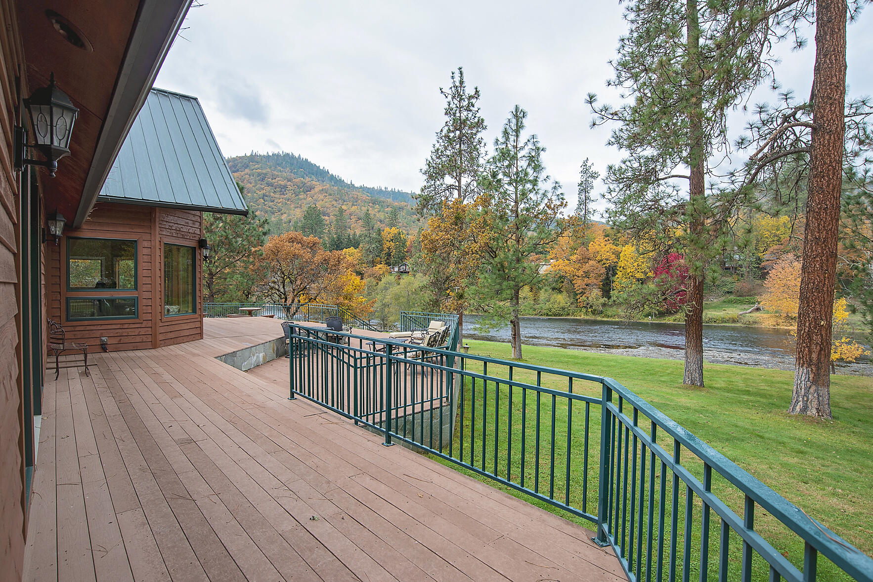 Live the riverfront dream on the mighty Rogue! No expense was spared on this spectacular 4866 sq.ft. home. The private 2.81 acres gently slopes to the river creating excellent river views & a tranquil setting to watch the Steelhead jump or the Ospreys dive for dinner. Upon entering the home you'll enjoy an expansive great room overlooking the deck & river that features high vaulted ceilings, rich wood floors & a stone fireplace. The magnificent kitchen is any chef's dream; featuring slab granite counters, Bosch gas cooktop, Viking double ovens, copper hood & custom fridge. Adjacent there is a large dining space, a breakfast nook & large family room. Wake up in your heavenly master suite with peaceful river views & enjoy the master bathroom that is more like your own private spa.  The additional 3 bedrooms all feature en suite bathrooms. The exterior has a wraparound deck, an oversize 3-car garage & irrigation from GHID.