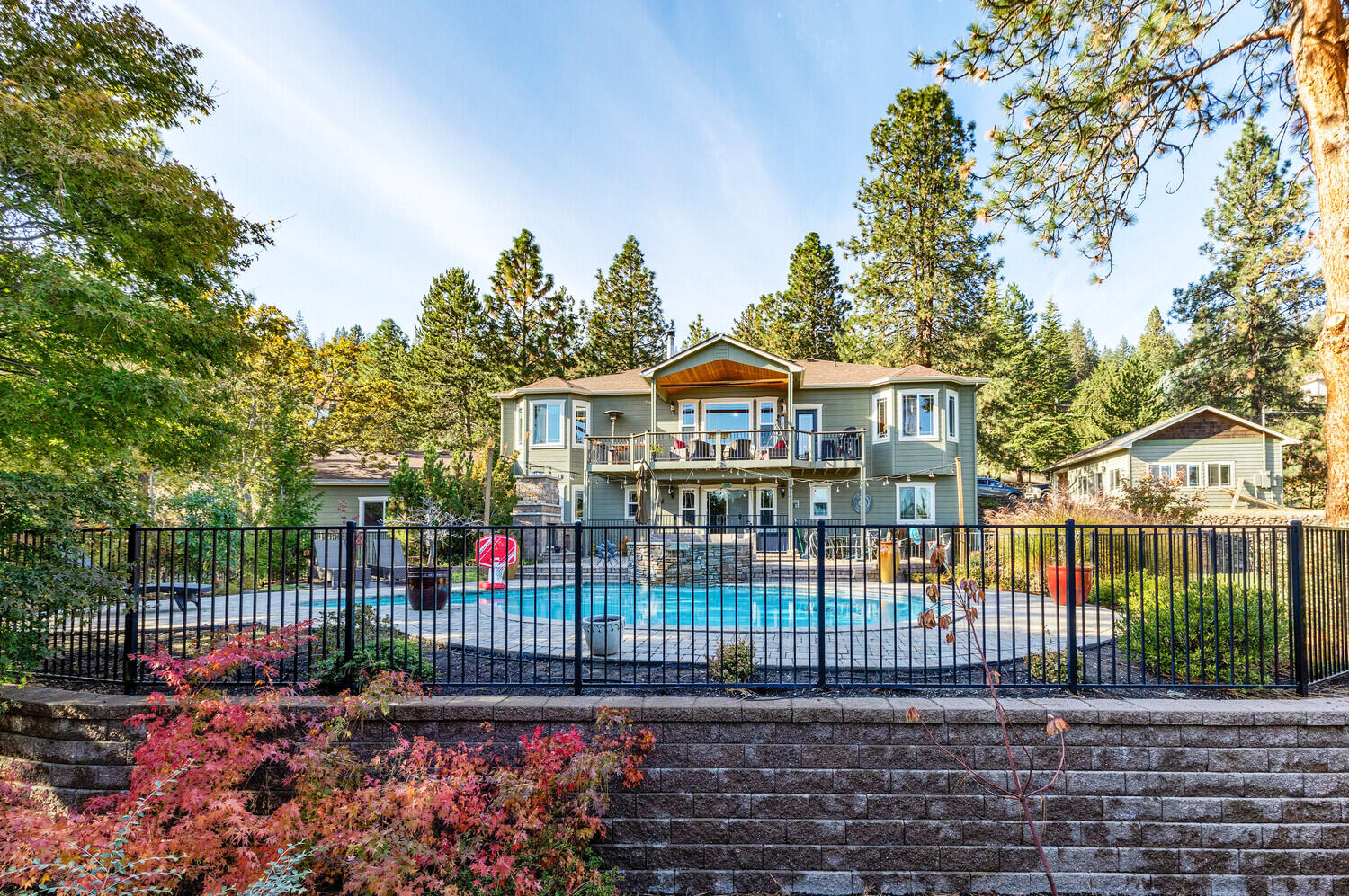 Location! Location! Location! This property sits on the desirable street of Tami Lane. Just 2 miles from downtown historical Jacksonville. This traditional country home is 1.73 acres of professionally landscaped and gated property. The main house over looks gorgeous views of Mt. Mcloughlin and city lights in the evening. Just over 3,000 sq ft with 4 bedrooms and 5 bathrooms. Newly renovated kitchen with beautiful marble countertops and ceramic tile backsplash in 2021. New hardwood floors and carpet in the bedrooms. Wood burning fireplace. Master is located on the main floor.  New Water heater, New well pump, new Septic. Guest house is unattached with it's own private garage. 1 bedroom, 1 bath and is 624 sq ft. This could be a perfect set up for an airbnb if desired. Over looking the mountain views is a private in ground heated pool and spa and  rock fireplace. Surrounding the property are a variety of fruit trees and a seasonal creek. A must see in person property.