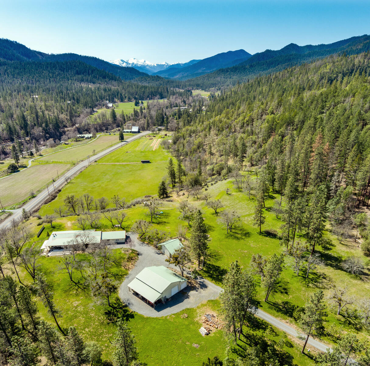 Enjoy the panoramic views from your own 110 private acres, bordered by BLM land, with over 1/3 mile of Applegate River frontage. Two large pasture areas with a combined 34 acres of Applegate River irrigation rights. Ranch style home built in 2002 sits on a knoll overlooking the red buttes with expansive valley views. This 2200 SF 3 bed/ 2 1/2 bath house has generous porches on three sides designed for ultimate indoor/ outdoor living and designed to maximize the views. Sunny cook's kitchen with ample counter space, generous pantry, and dynamite view from the kitchen
sink. Covered breezeway leads to an oversize 2 car garage. Sweet detached 576 SF guest cottage with vaulted ceiling, surrounded by pollinator gardens. Large RV garage/ shop space with plenty of room for projects, toys, or storage. With excellent sun exposure, this property would be great for vineyards, horses, hayfields, or a serene natural retreat.
