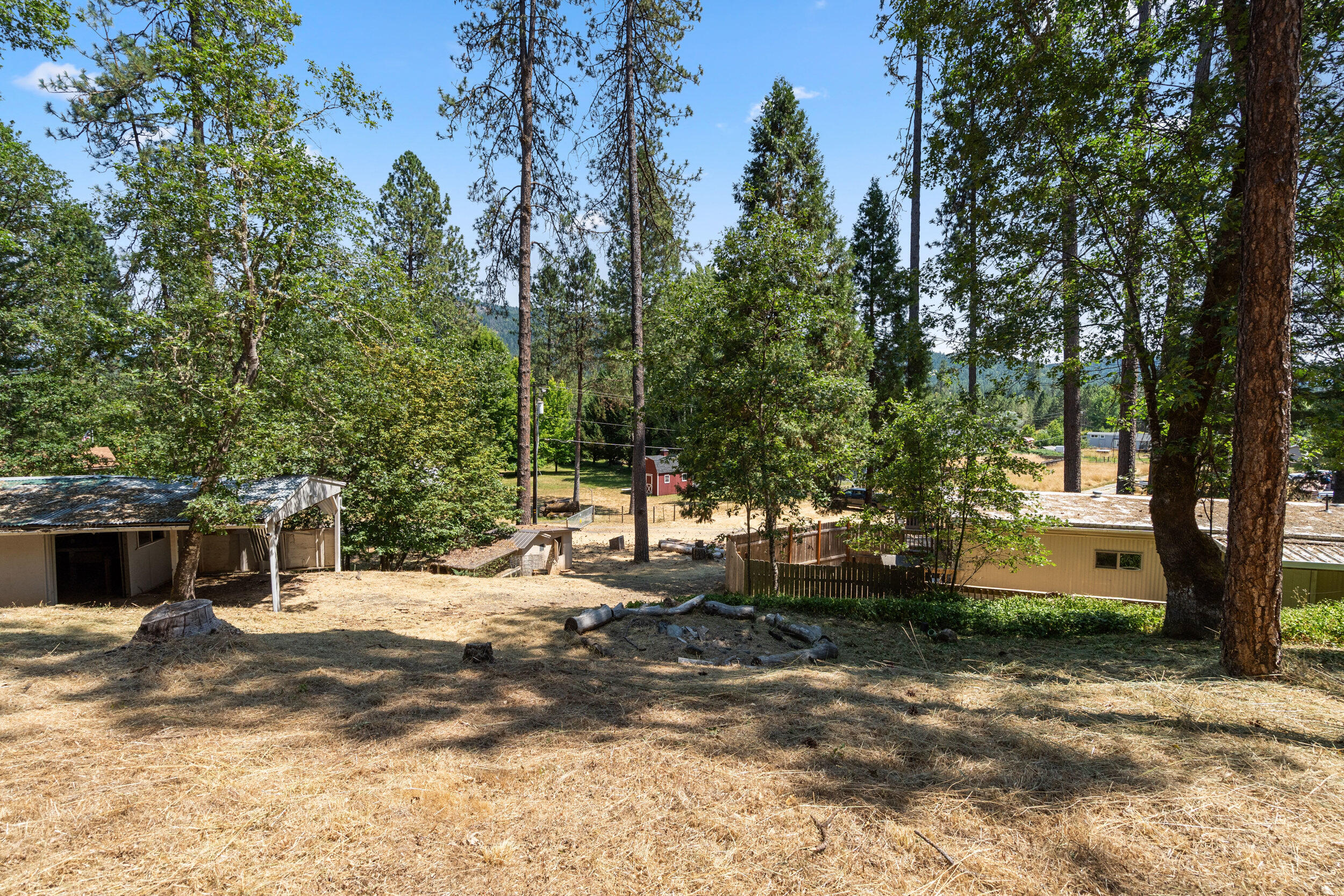 One acre in Rogue River! Property has some great features such as a large tiled walk in shower but is in need of repairs. A good portion of the acre is fenced. Includes a shed and carport. No seller carry.