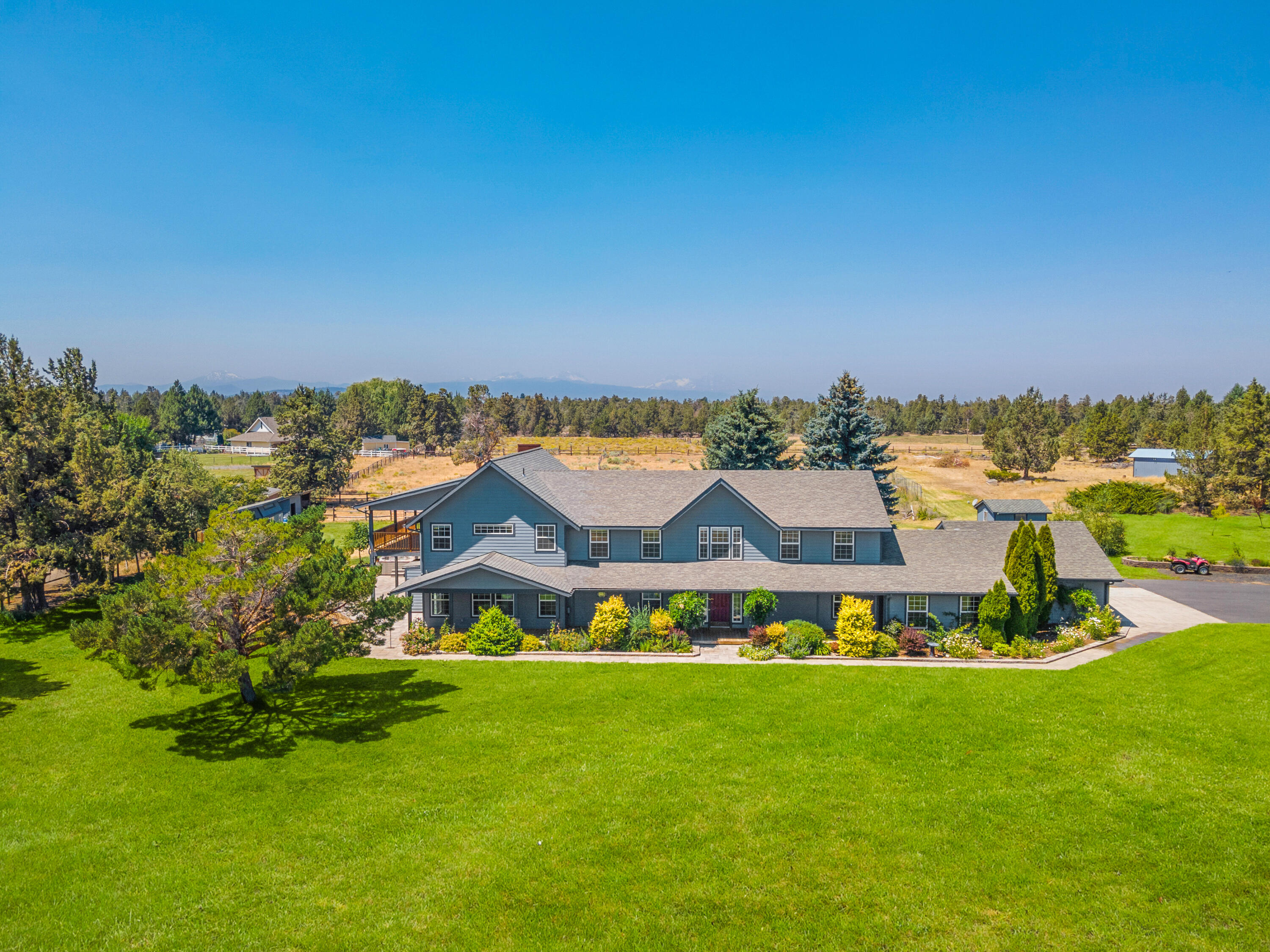 Just 15 mins to downtown Bend, 10 mins to Pine Nursery Park & 10 mins to the hospital, this property delivers an experience of living in serenity while offering convenient proximity. Set on 8 acres w/ 3 acres of irrigation, this updated home provides a primary suite on the main level, office, exercise room & kitchen designed to entertain. The second level creates space for all w/ a second primary suite w/ private balcony, multiple bedrooms w/ private vanities & large bonus room w/ access to a spacious covered deck. The park-like grounds provide opportunities to cultivate the fields for various hobby crops, poultry coup, shop & detached office w/ heating & cooling. The outdoor spaces embody the meaning of living in Central Oregon; w/ a hot tub, gas fireplace, sauna, multiple decks & patios to be enjoyed all year around. Plus, RV pad with water, power & sewer hookup. All this with beautiful Cascade Mountain views, inspiring sunrises, peaceful sunsets & no HOA!
