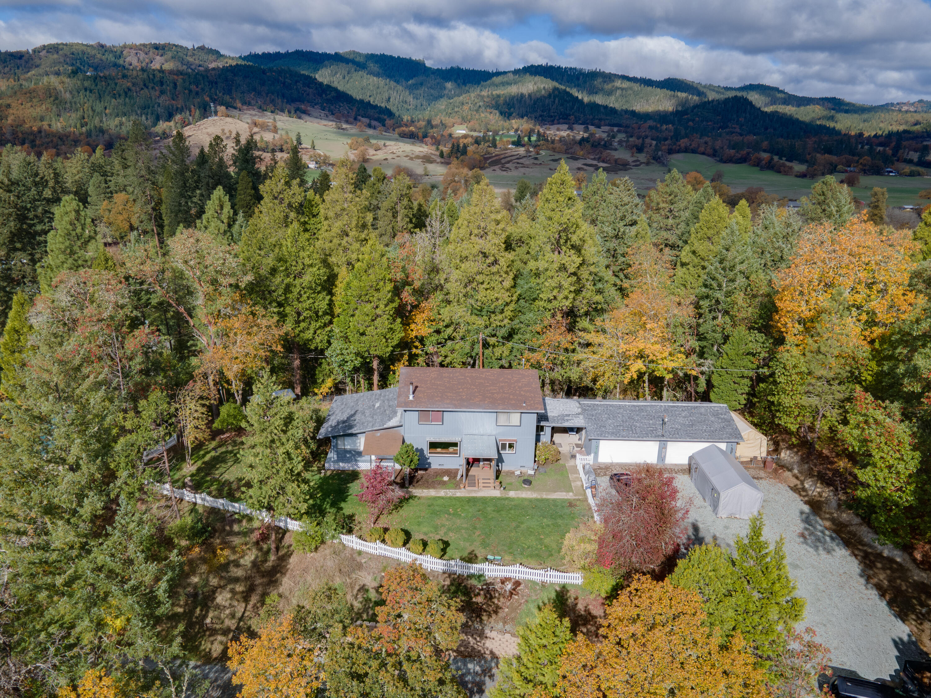 Discover this spacious 4-bedroom, 2-bathroom home offering 2,336 square feet of comfortable living space, perfectly situated on 1.3 private, tree-lined acres. This well-maintained property combines peace and privacy with thoughtful updates throughout. Inside, you'll find a nice open kitchen that flows seamlessly into the living areas, perfect for cooking, entertaining, or family gatherings. The huge primary bedroom offers plenty of space to unwind, while the newly updated downstairs bathroom features a relaxing soaking tub, new flooring, fixtures, window, and fresh paint. The home also boasts a newer roof (approx. 2 years old), newer wood stove, and a newly built front porch, adding both comfort and curb appeal. Car enthusiasts or hobbyists will love the massive 4-car garage, complete with a new epoxy floor — offering ample room for storage, projects, or extra vehicles. With numerous upgrades and meticulous care, this property is move-in ready and truly one-of-a-kind.