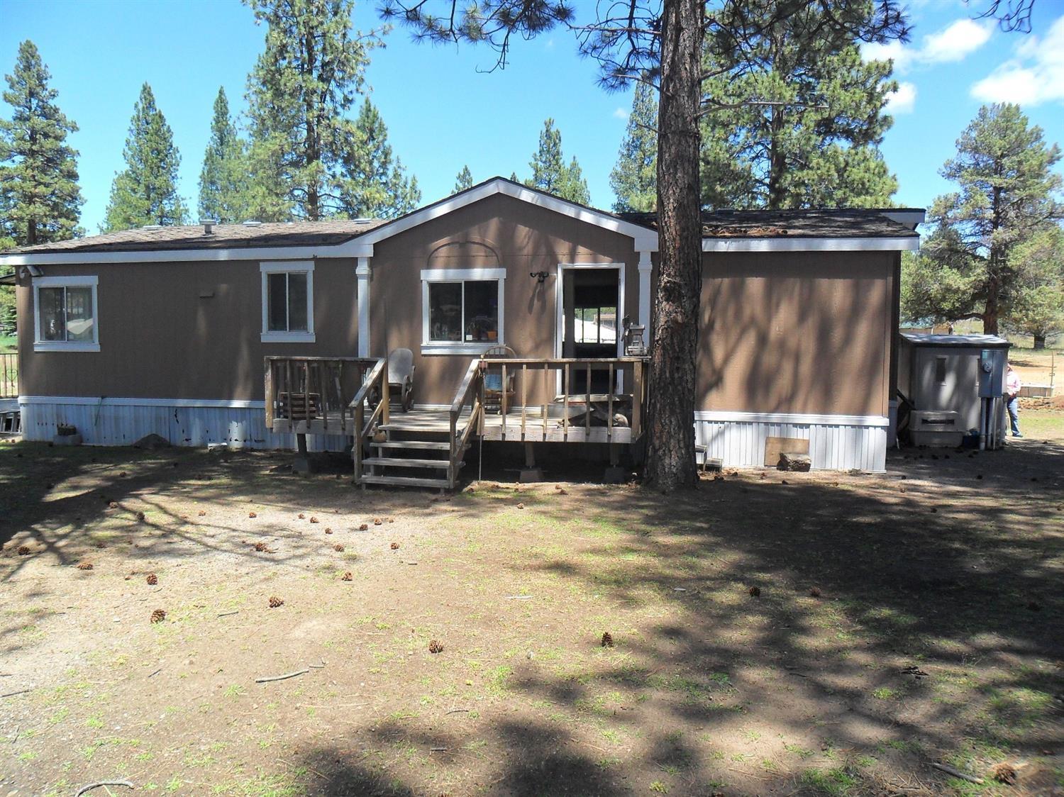 Terrific 3 bedroom, 2 bath manufactured home on over 2.4 acres. Large master bedroom and bath, with a large living room. Fenced and cross-fenced for your animals, partially timbered and on a paved road. The barn and shed are close to the rear of the home and there is a garden area for true country living. The home is on a post and pier foundation with skirting on the home and deck on the rear and porch by the front door.
