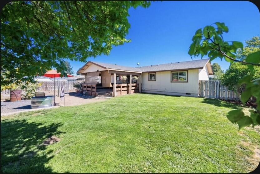 3 bedroom, 1 bath home with fantastic features inside and out! This charming home has had some beautiful updates. Including Stainless Steel appliances, updated countertops, cabinets, fresh paint and gorgeous Pergo floors throughout. The property offers many outdoor conveniences including RV parking, alley access, a beautiful back yard with fruit trees, well manicured grass and a flower garden. There is also a fenced dog yard that could easily be used for storage, more yard, or a beautiful garden space. The possibilities are endless! Relax on the huge covered deck, perfect for entertaining or simply unwinding. Located within walking distance of schools and the fairgrounds. Also close to town for easy amenities and convenience. Don't miss the opportunity to make this wonderful property your new home!