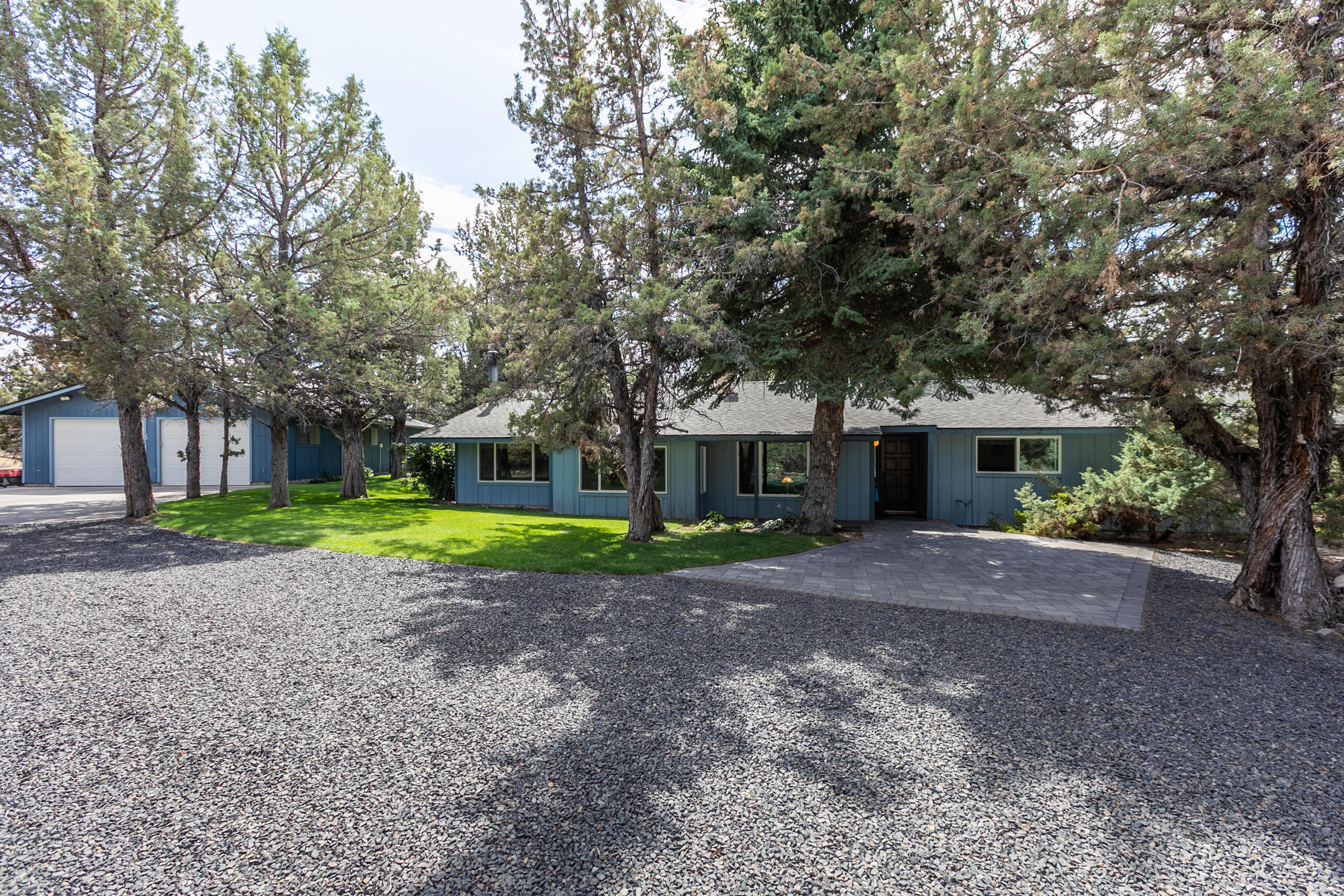 Beautiful Private  Park like setting with nearly 3 acres, and a 2003sf home with large 1800sf Garage/Shop and an additional back drive way.   Out back you will find a large patio and a big lawn area with shade trees, a fenced in garden and a wood shed. Inside are 3 bedrooms, 1.5 bathrooms. On the other end of the home is an office with its own private entrance, a large bonus room with built in's and a certified wood burning stove. Refrigerator, range, microwave, dishwasher are included and are in good working order.  A large utility room with storage cabinets and water heater in good condition. 
Security lighting outside - motion detecting flood lights. Plenty of room for your RV parking and toys.