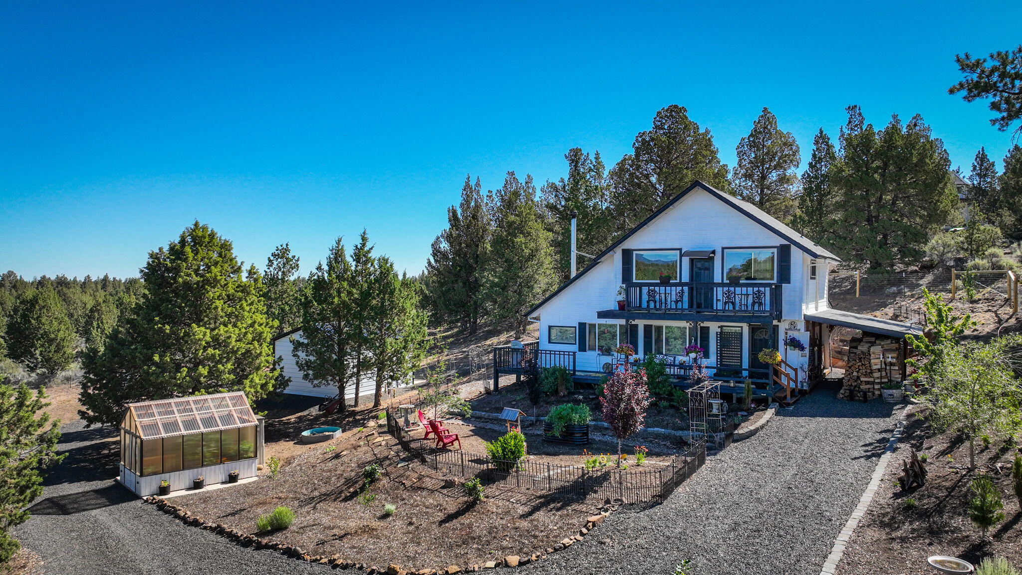 Charming 3-bedroom, 1.5-bath home on 4.56 acres with 1,680 sq ft of living space and stunning mountain views. Nestled between Bend and Sisters, this peaceful property features vaulted ceilings, a warm rustic interior, and a thoughtfully designed kitchen. Enjoy the privacy fenced with an automatic gate, single-car detached garage, greenhouse, and wrap-around deck. A perfect blend of comfort, space, and Central Oregon beauty—just minutes from town amenities.