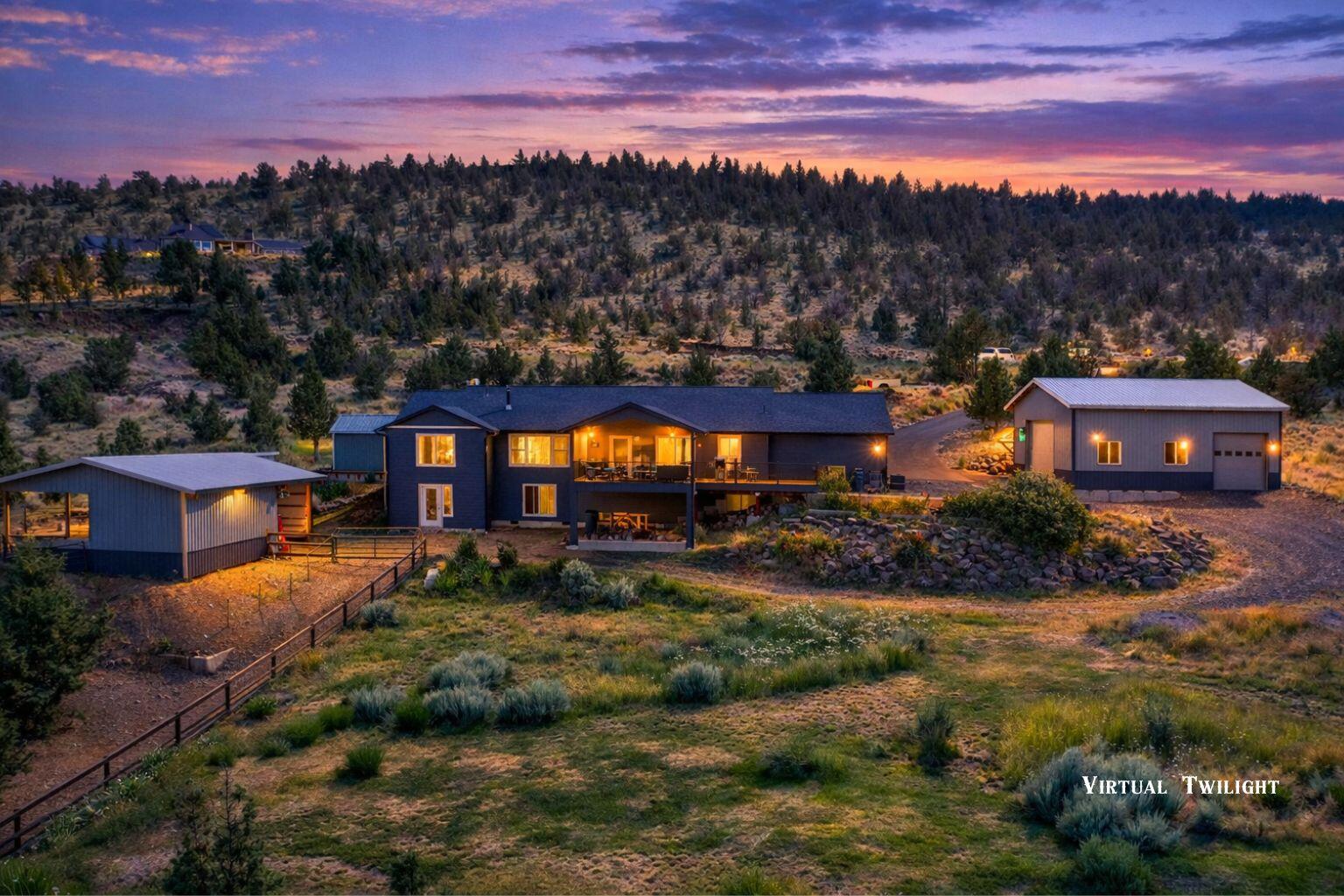 Perched on 2 scenic acres in Scenic Vista Estates, this beautifully maintained single-level home offers sweeping territorial and mountain views just minutes from Prineville. Filled with natural light, the open great room features vaulted ceilings and a striking propane fireplace, creating a warm and inviting space for everyday living and entertaining.
The kitchen is thoughtfully designed with quartz countertops, a large island with storage, instant hot water, and a recirculating hot water system. Quality upgrades include bamboo flooring with a 3/8'' subfloor, solid interior doors, whole-house water filtration, and heated tile floors in the primary bathroom.
Outside, the property shines with a 28x36 shop with loft, 220 power, drains, and full RV hookups. Horse and hobby amenities include a 2-stall barn with hay storage, fenced paddock, and riding area. The landscaped grounds feature a koi pond with waterfall, greenhouse, fenced garden, powered shed, paved drive, and 400-amp service.
