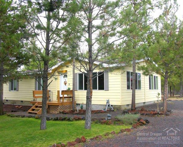 2004 Built Home Backs 100's Acres BLM Land! Only used as a 2nd/Vacation get-away, this 3Bd/2Ba home is in perfect condition! Features: vaulted great room, open dining/kitchen w/large B-Bar, tile backsplash & trim, pantry, vaulted master suite w/walk-in & private bath w/large shower stall, Energy Star insulation+ package, detached insulated garage/shop w/storage wing, frame storage buildings, front deck & covered back deck, nicely landscaped w/circular driveway, cement siding & end of the road privacy!
