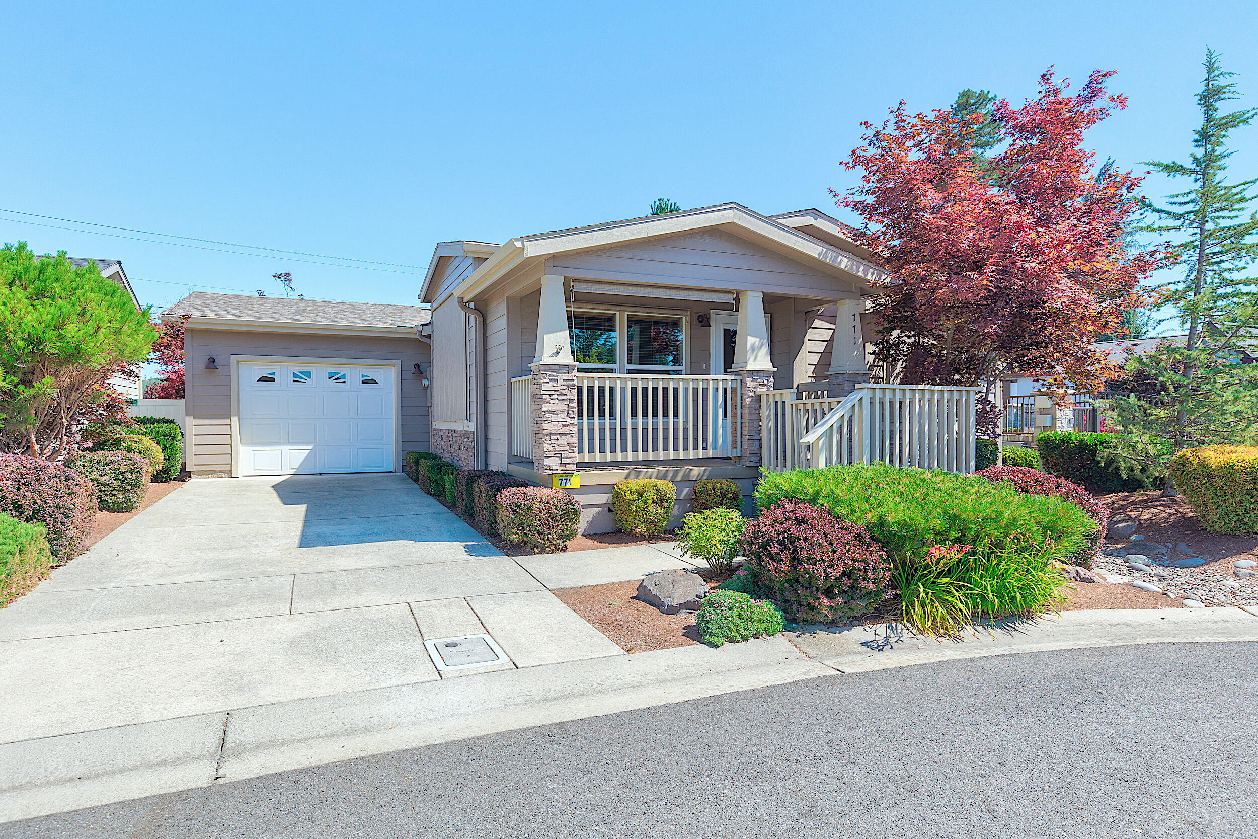 Located in the wonderful city of Grants Pass, Westlake Village is a premier 55+ community designed for comfort, connection, and carefree living! This beautifully maintained 1,275 sq. ft. home features a bright, open kitchen with ample cabinetry and a convenient breakfast bar, perfect for casual dining or entertaining. The living room, with vaulted ceiling, is filled with natural light from expansive windows, creating a warm and inviting atmosphere. Primary suite is spacious and offers a generous bathroom with a large tile shower and abundant closet space for all your needs. A one car garage adds convenience, while the gated, meticulously landscaped park offers peace of mind and stunning surroundings. Come enjoy the best of 55+ living — secure community, stylish home, and surrounded by beauty! You'll love it here!