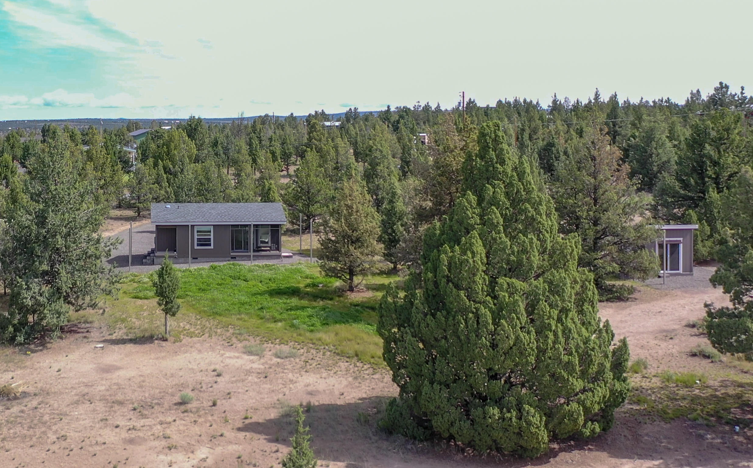 Large living with a small foot print in this well laid out floor plan with one bedroom and one bath, screened back patio and an additional 100 sq ft studio that is insulated with power. Property is almost 2 acres with a private well and boarders thousands of acres of BLM of the back of the property, ride your horses or ATV right out the back. Posts around home and studio are for sun shades.