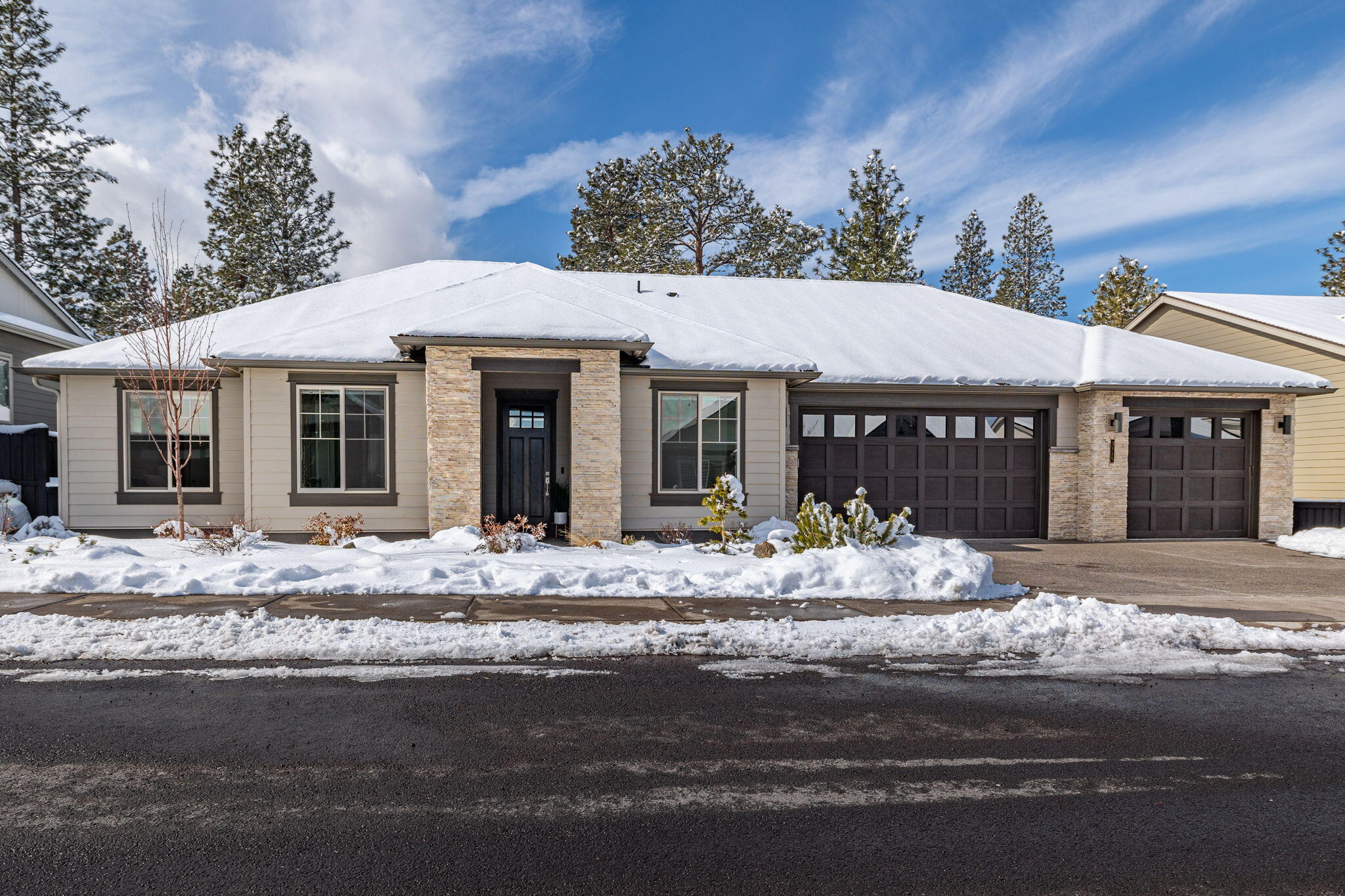 Stunning one-level contemporary home on River's Edge Golf Course. This like new Pahlisch home has been lightly lived in and meticulously maintained. The Great Room floorplan is an entertainer's dream, featuring a gourmet kitchen with a large island, eating bar, walk-in pantry, an upgraded appliance package, plus a built-in desk space or wet bar area. Luxurious custom finishes throughout, a floor-to-ceiling tile fireplace with built-in cabinets, and abundant windows looking out to the trees and golf course. The primary suite is nicely separated from the other guest bedrooms and features a large custom tiled shower, double vanity, spacious walk-in closet, and a soaking tub. The private covered patio offers a view of the golf course, daily wildlife passing by, and beautiful pine trees. This home has many upgrades throughout, smart home features, and a spacious three-car garage. Conveniently located near the Bend River Trail, quick access to the Parkway, downtown, and the westside.