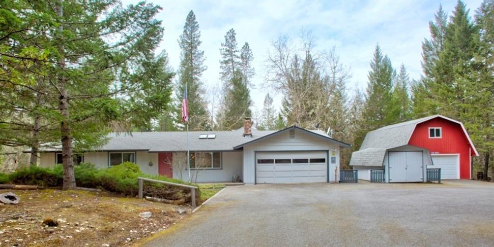 The one you've been waiting for... privately set on 5 acres, this one story home will surprise you with its contemporary interior, designed and remodeled by the well known Michael and Carolyn Jorgenson Design and Construction. Gated entrance, paved driveway, 1893 square foot home with spacious covered patio, attached garage with cabinets and shelves, big shop building with concrete floor and full loft, garden equipment shed, storage shed, fenced garden area, and peacefulness. Tile Entry, Living room and Dining area, bright spacious Kitchen with beautiful cabinetry, an expanse of granite counter tops, tile flooring, double farm sink, bar sink, all appliances including a wine fridge, Breakfast nook with French doors to the patio, Family room area, 3 bedrooms and 2 baths including master suite with 3 closets with built in cabinetry, and master bath with double sinks, tile flooring, and shower.
