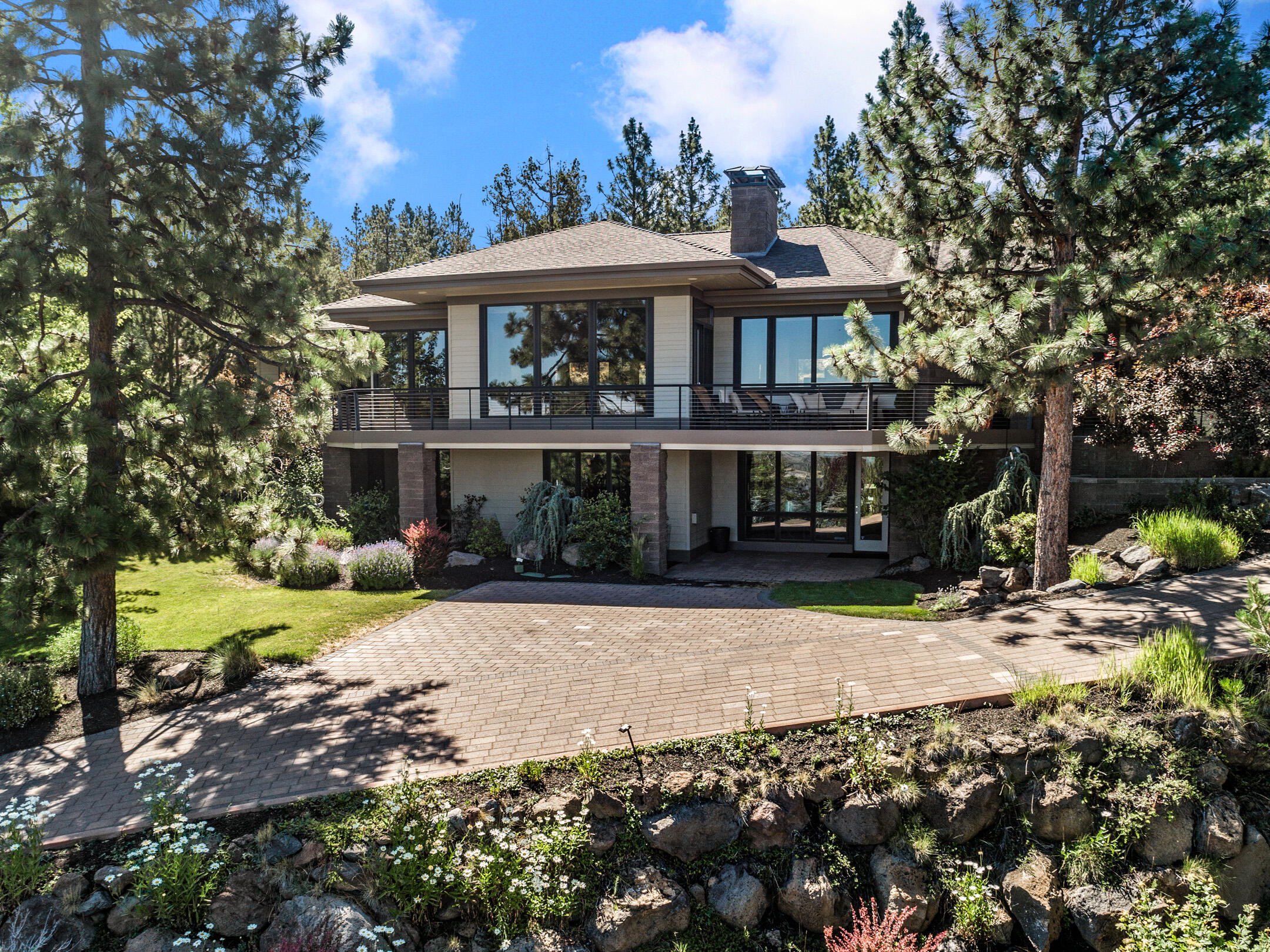 First time on the market, builder's personal home on Awbrey Butte. Amazing design and architecture throughout this NW contemporary home. Main level living with breathtaking mountain and city views.  Expansive chefs' kitchen with Viking commercial appliances, a huge granite island, custom vent hood and stone backsplash. Beautiful wine room and wet bar for entertaining. The main level master suite has a spectacular bathroom with dual vanities, tiled shower, jetted tub and a walk in closet. Large office with beautiful mahogany cabinets and great views. Enjoy outdoor living from both the wrap around front deck and private back patio with water feature. Downstairs features two bedrooms, both with full bathrooms and a large media room with wet bar. Three car garage with additional storage and heated driveway. One of the best lots and homes on the entire butte, don't miss out on this opportunity to own this builder's custom home.