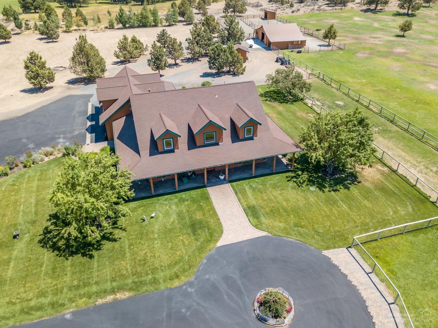 Hard to find turnkey horse property! Beautiful custom home, 9.91 acres with timed & underground irrigation, large barn with stalls with a bath and laundry, dry paddocks and fenced pastures all with HUGE Cascade Mountain views and minutes to BLM. An open floor concept with vaulted ceilings and the master on the main. Upon entering the home you will be taken by a beautiful custom wood staircase and wrought iron handrail that sets the tone for the details throughout this home. Wood floors, solid wood doors and the wood wrapped windows frame the abundance of natural light that flows from the many windows. There are 2 large guest rooms with guest bath, loft and a bonus room upstairs. Outside the home is wrapped with a covered paver patio which is extended out the back and has a heated water feature for year-round enjoyment. There are tranquil views from every angle of this home; Cascade Mountains, ponds and pastures. Bring the kids, the horses and dogs there is plenty of room for all.