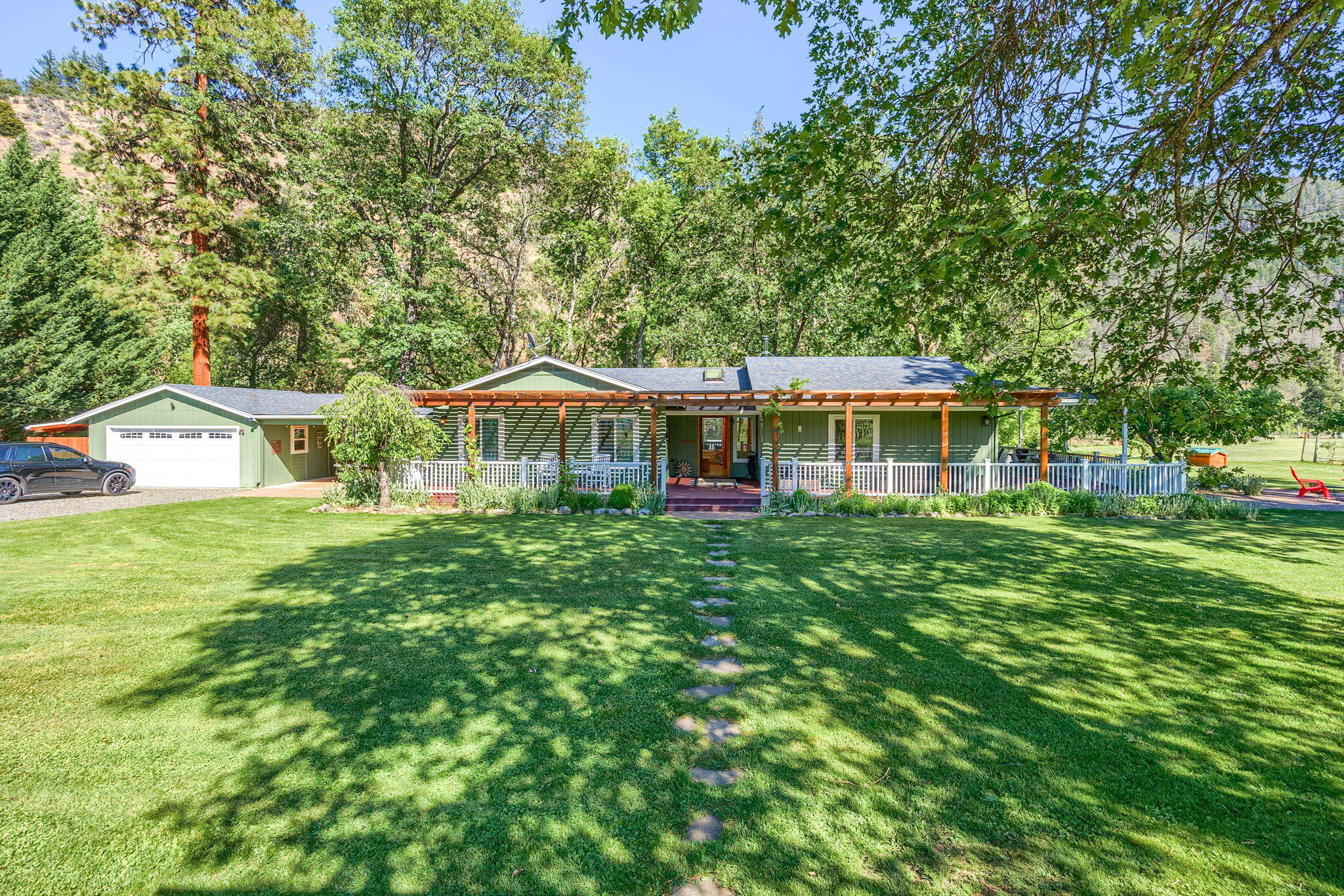 Rivercrest Ranch overlooking the Applegate River w/irrigation rights & boutique vineyard of approx. 3.2 acres of vines, Pinot Noir vines, Grenache vines and Counoise vines planted w/4X8 rows. This beautiful parklike setting sets the stage for entertaining, relaxing by the covered deck overlooking the river or sitting around the firepit on the full wraparound porch around the home. Lg fenced-in gardens, lg lavender field, inground sprinklers for the lg lawn areas. She Shed w/full bath & mini kitchen setup w/covered porch, paver patio w/brick bbq. Lg Barn w/covered areas. Custom Built home Bruce Brown Const. w/vaulted ceilings, granite counters in kitchen, Great Room w/woodstove & lg slider & windows to take in views. Both Bathrms updated w/tile showers & floors. Primary Suite w/lg slider to sitting rm off covered deck. Lg breezeway for more entertaining & finished 2 CA garage or Rec rm w/carpet. 2 tax lots w/possible build another dwelling plus backs up to BLM land.