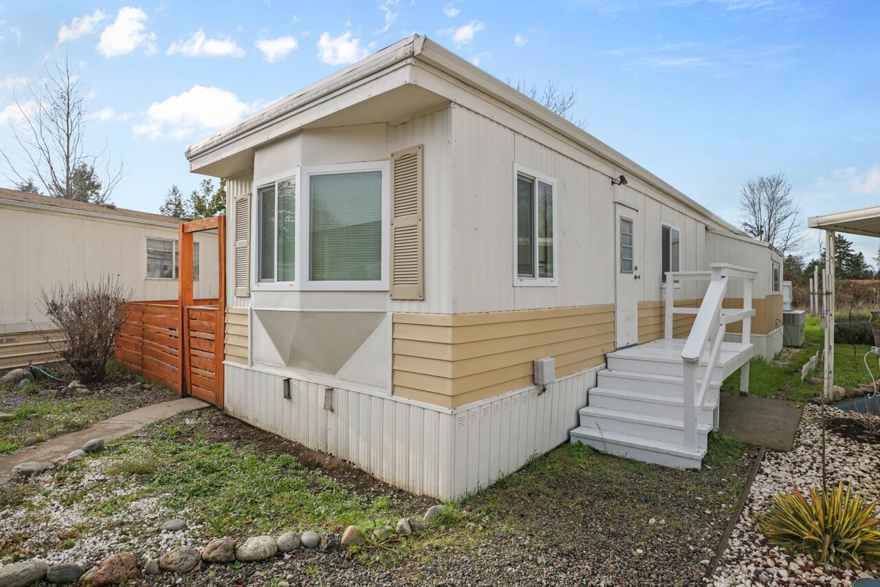 SELLERS MOTIVATED BRING ALL OFFERS! Beautifully remodeled 2-bedroom, 2-bath mobile home that's truly move-in ready. Thoughtfully updated throughout, the modern kitchen shines with stylish butcher block countertops and newer appliances, including a stove and refrigerator. A new washer and dryer are also included for added convenience.
Energy-efficient double-pane vinyl windows enhance comfort year-round, while the new roof installed in 2023 provides long-term peace of mind. Step outside to a fully fenced yard with a wood privacy fence—ideal for relaxing, entertaining, or enjoying time with pets. The spacious wood deck extends your living space, and a detached carport plus additional parking add everyday practicality. This home is located in a beautifully maintained 55+ community set along the scenic Rogue River, where peaceful ponds greet you as you drive in, creating a serene and welcoming atmosphere. Residents may have up to two pets and enjoy a friendly, well-kept neighborhood.
